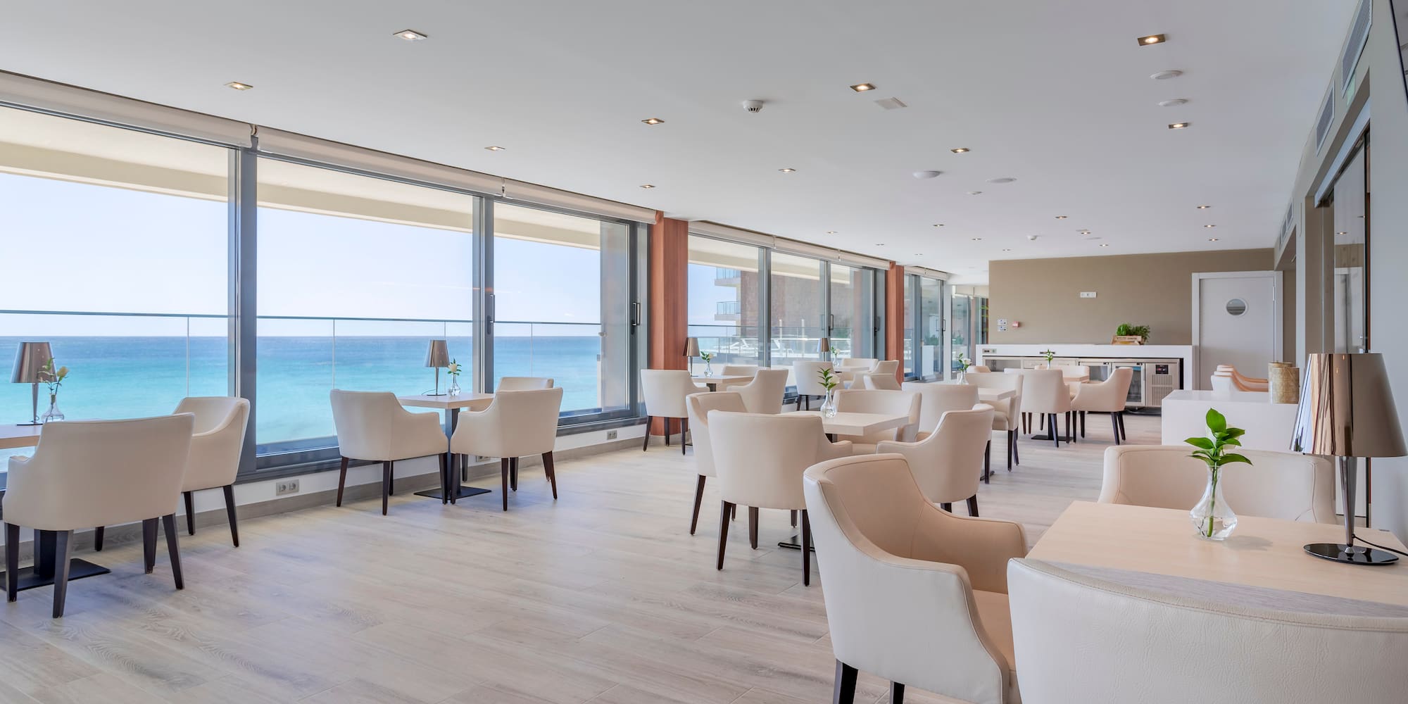 a room with white chairs and tables