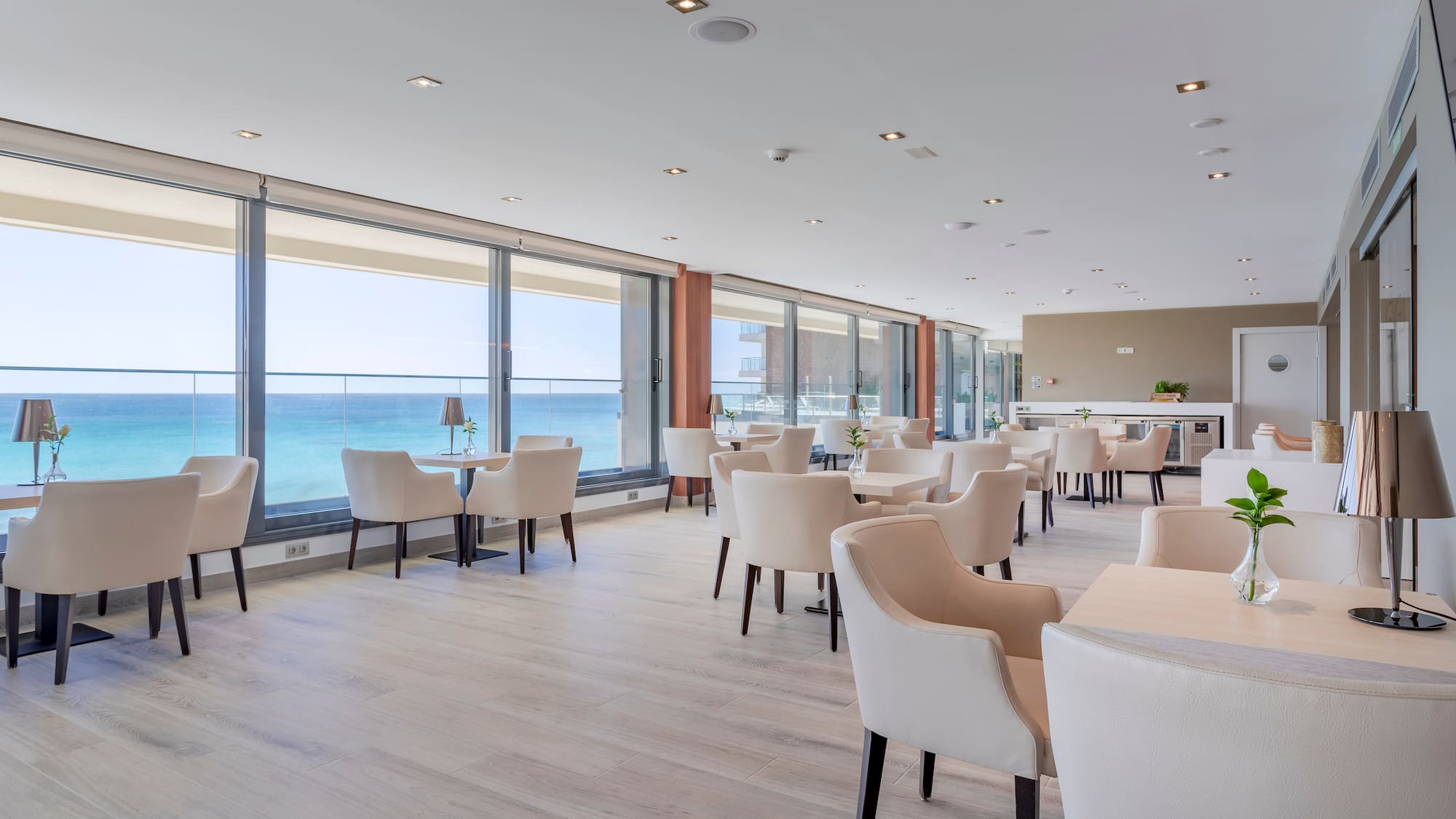 a room with white chairs and tables