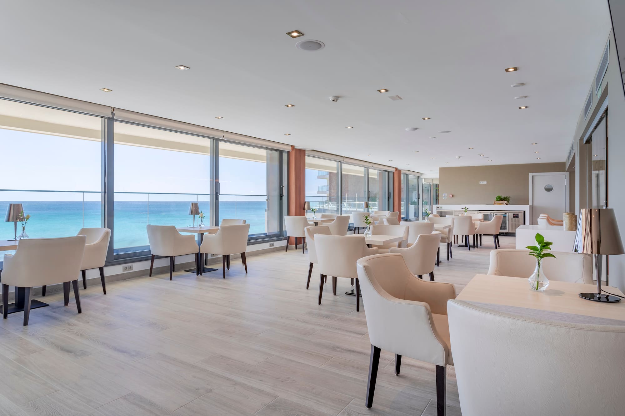 a room with white chairs and tables