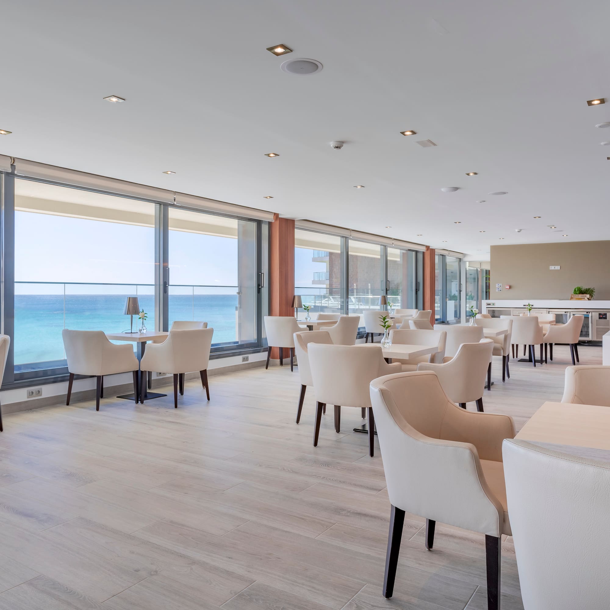 a room with white chairs and tables