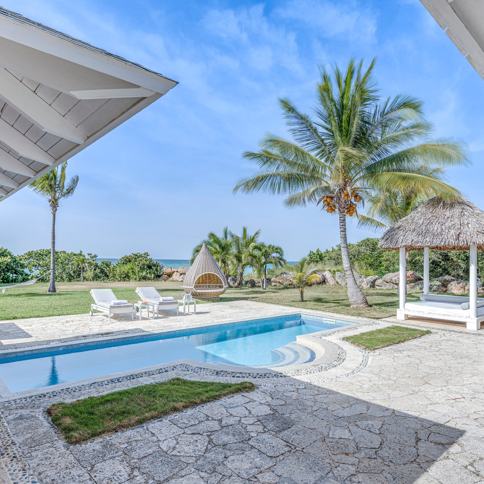 a pool and a gazebo with palm trees
