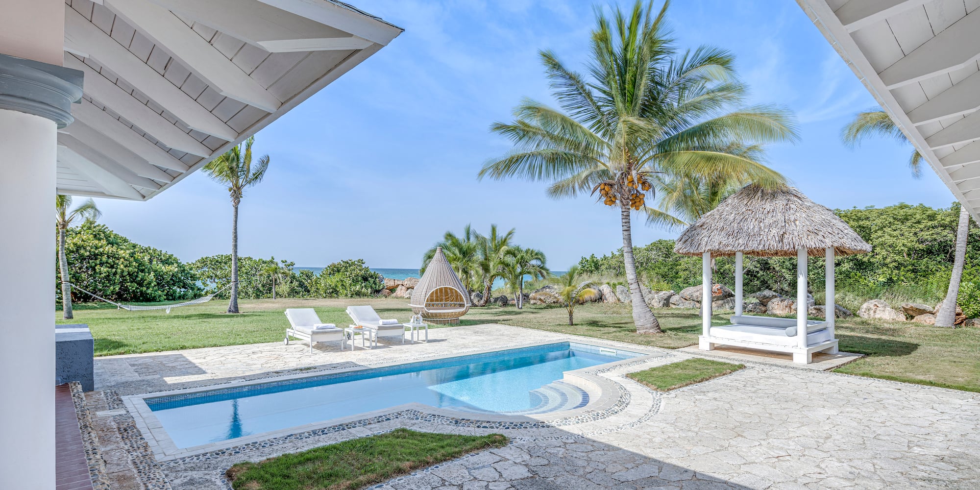 a pool and a gazebo with palm trees