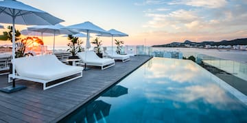 a pool with chairs and umbrellas