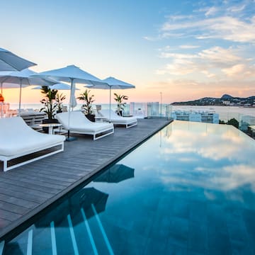 a pool with chairs and umbrellas