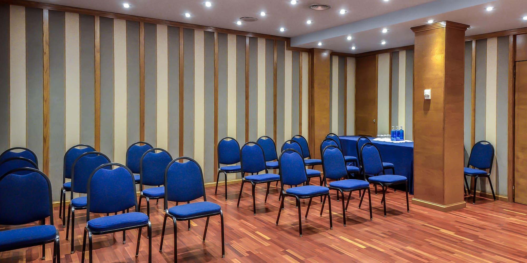 a room with blue chairs and a table