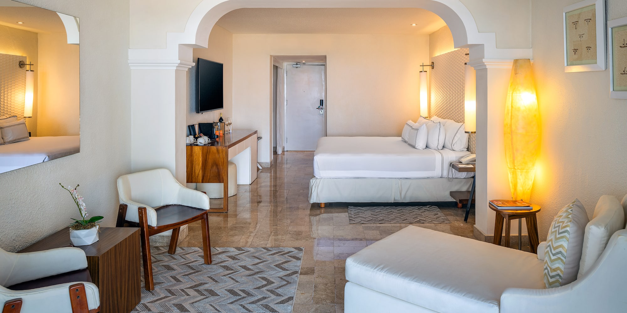 a room with a bed and a television