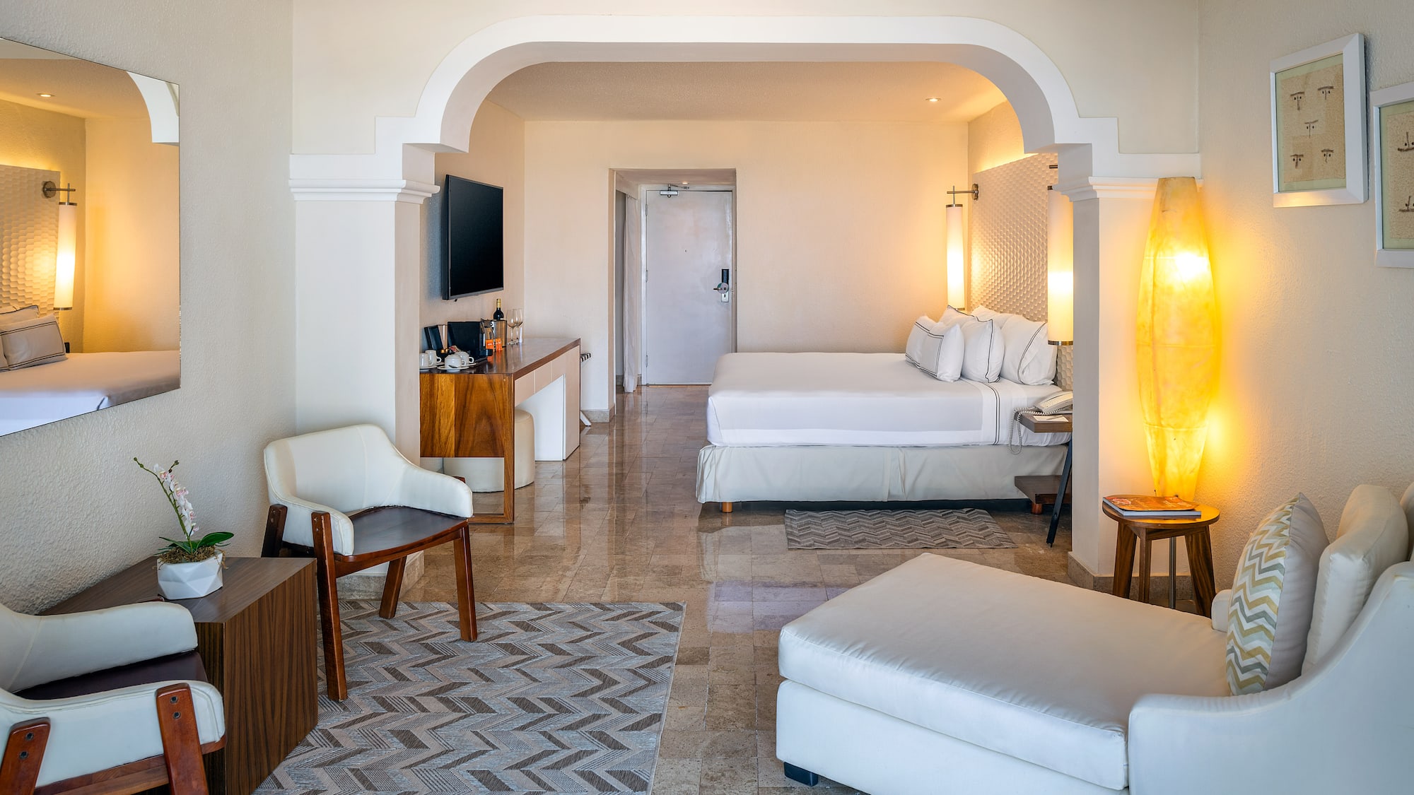 a room with a bed and a television