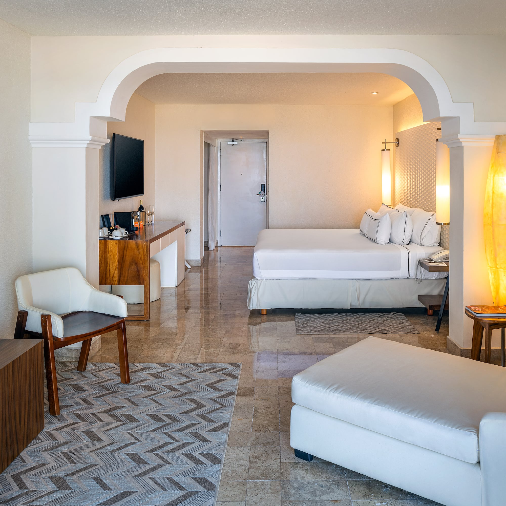 a room with a bed and a television