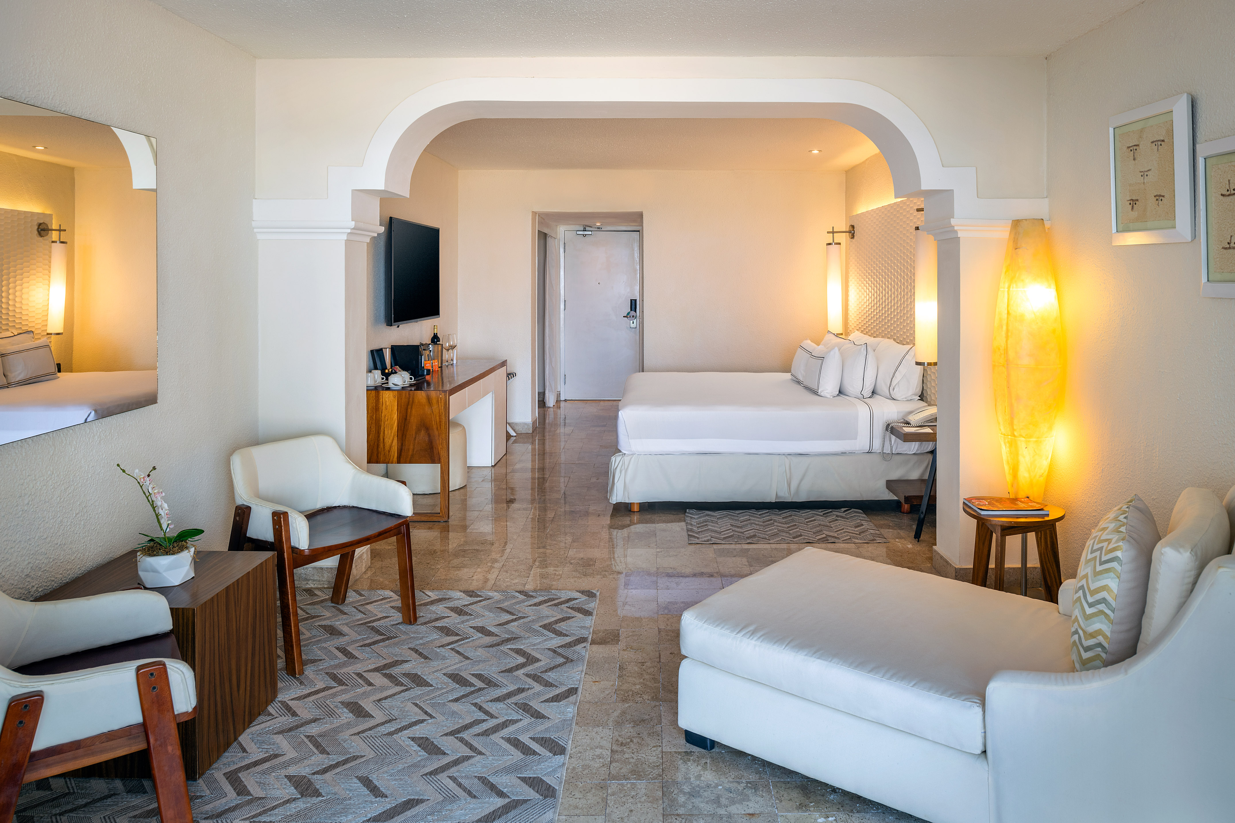 a room with a bed and a television