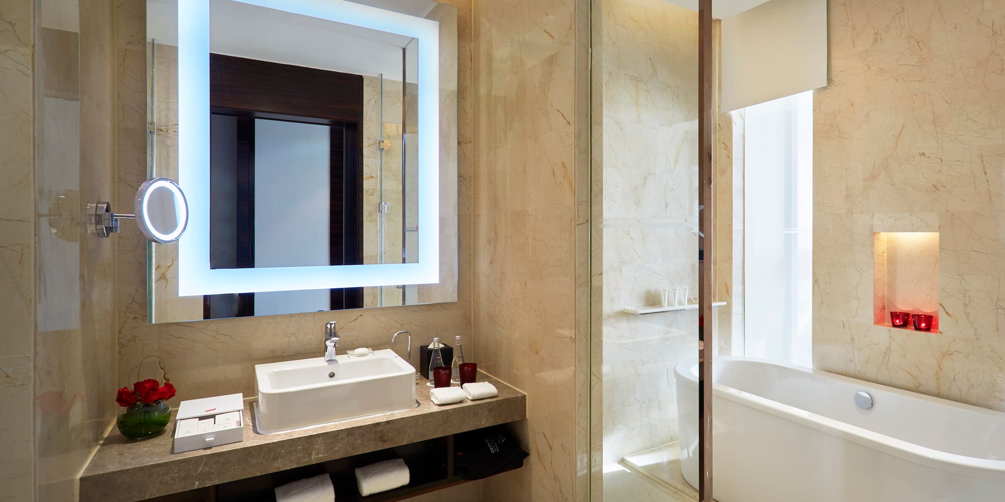 a bathroom with a large mirror and a tub
