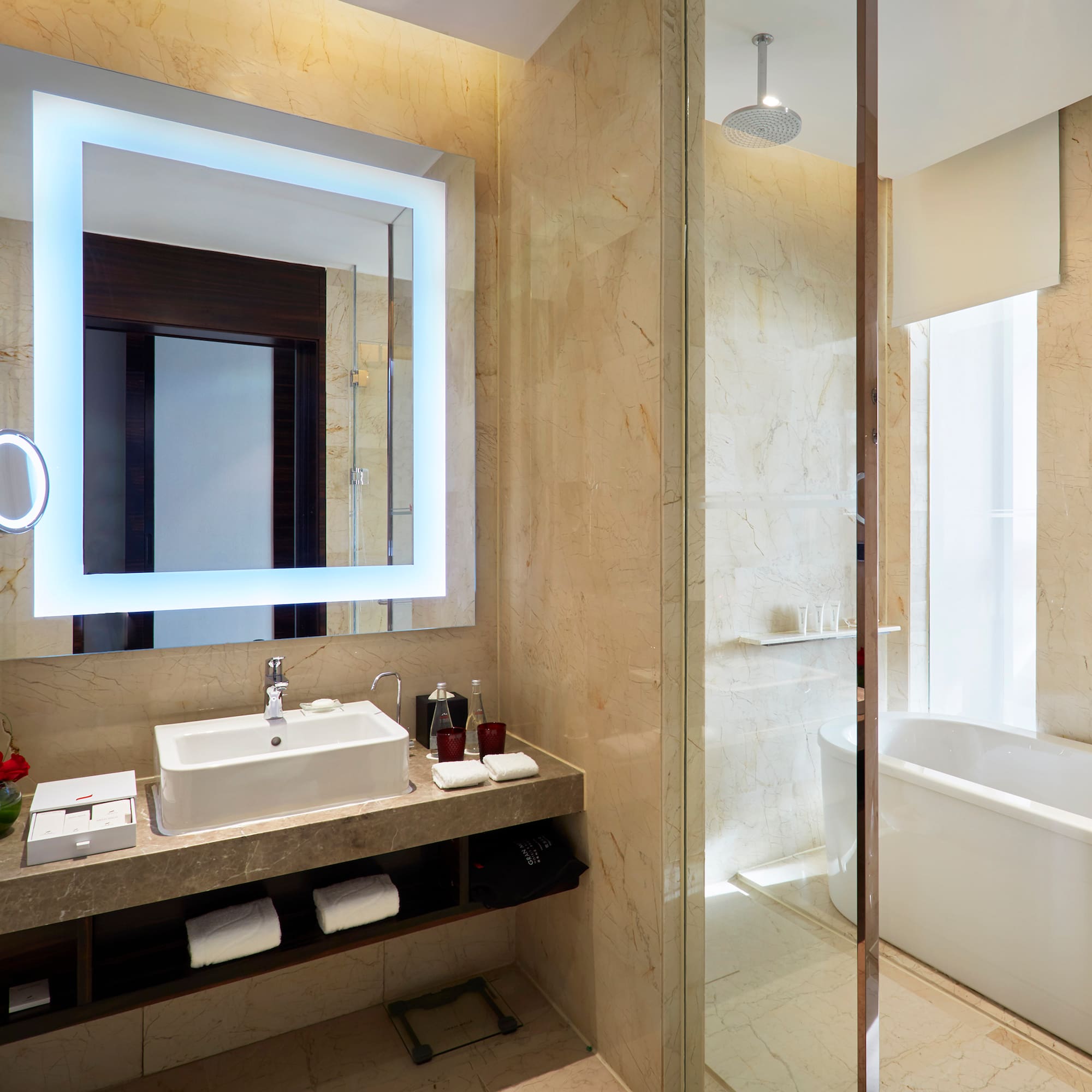 a bathroom with a large mirror and a tub