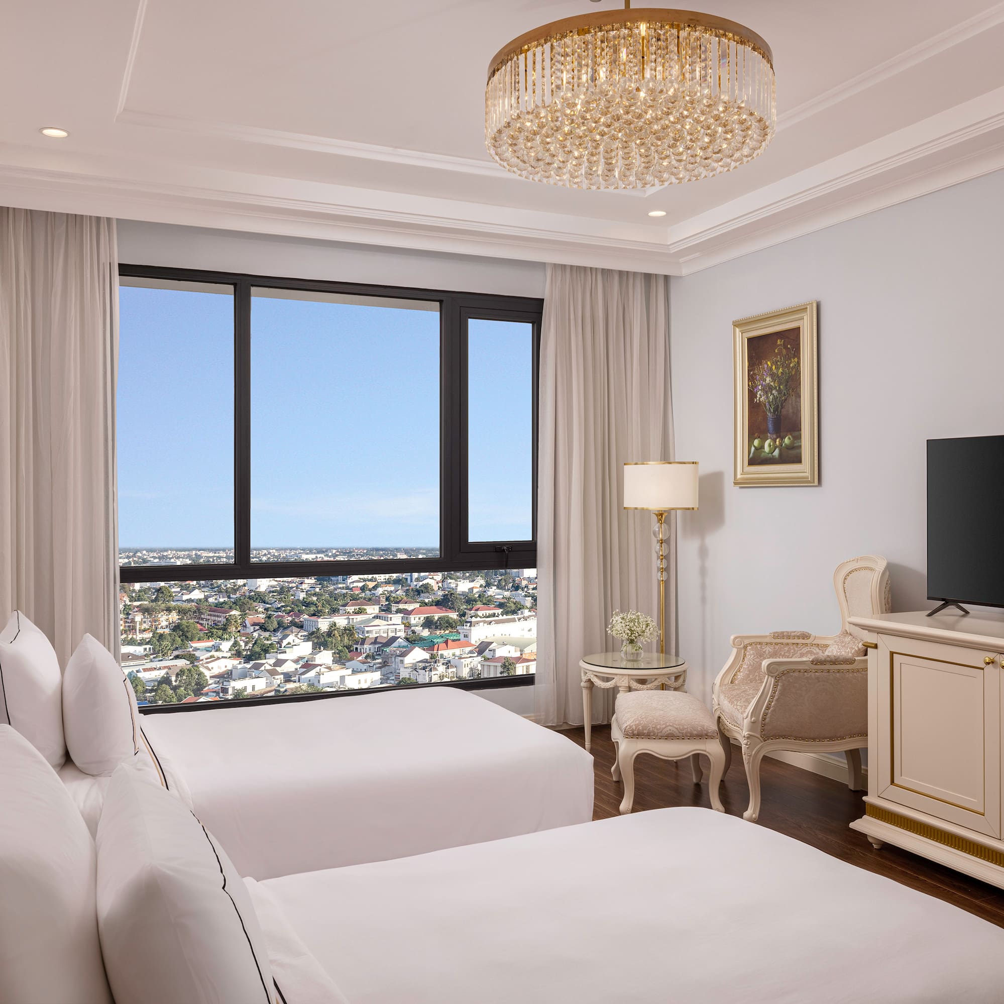 a room with two beds and a television