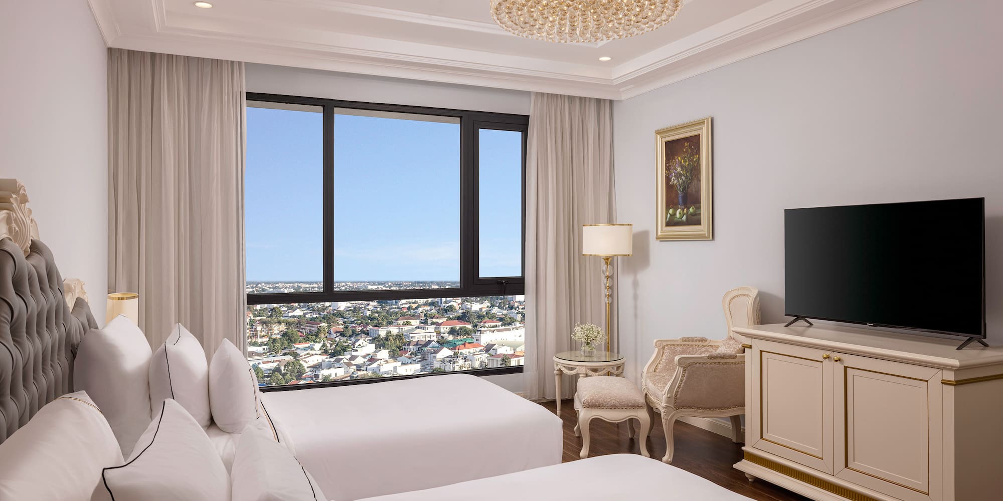 a room with two beds and a television