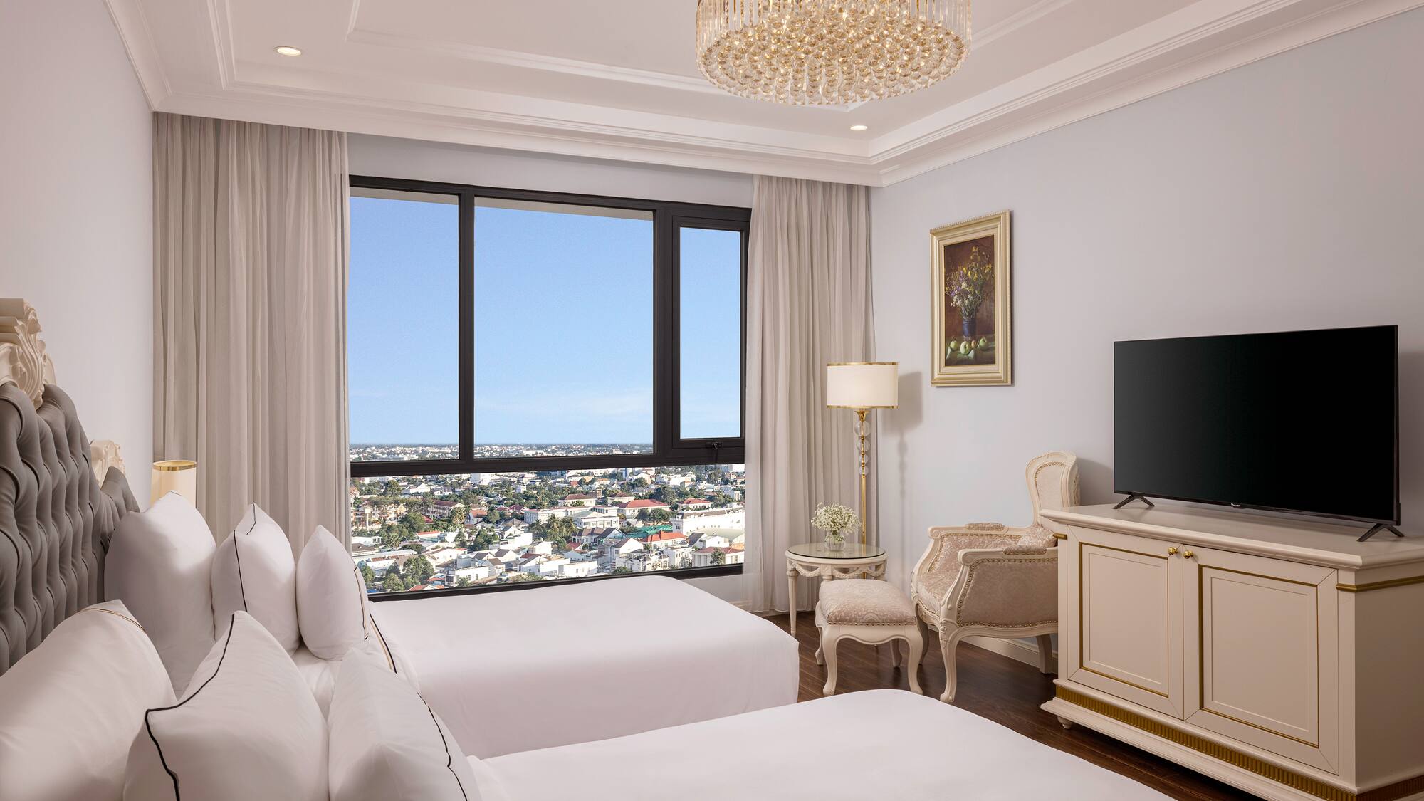 a room with two beds and a television