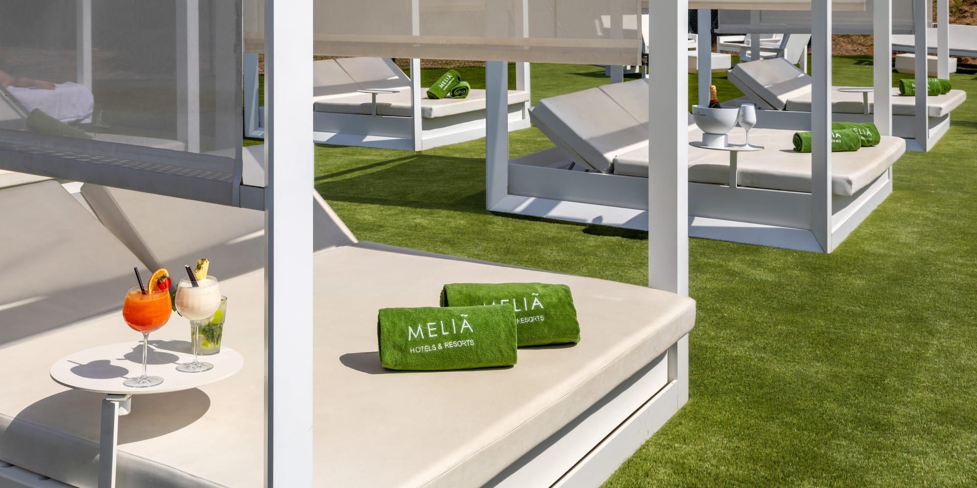 a lounge chairs and a drink on a table