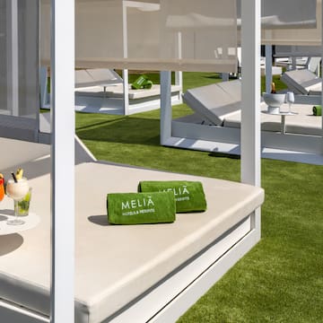 a lounge chairs and a drink on a table