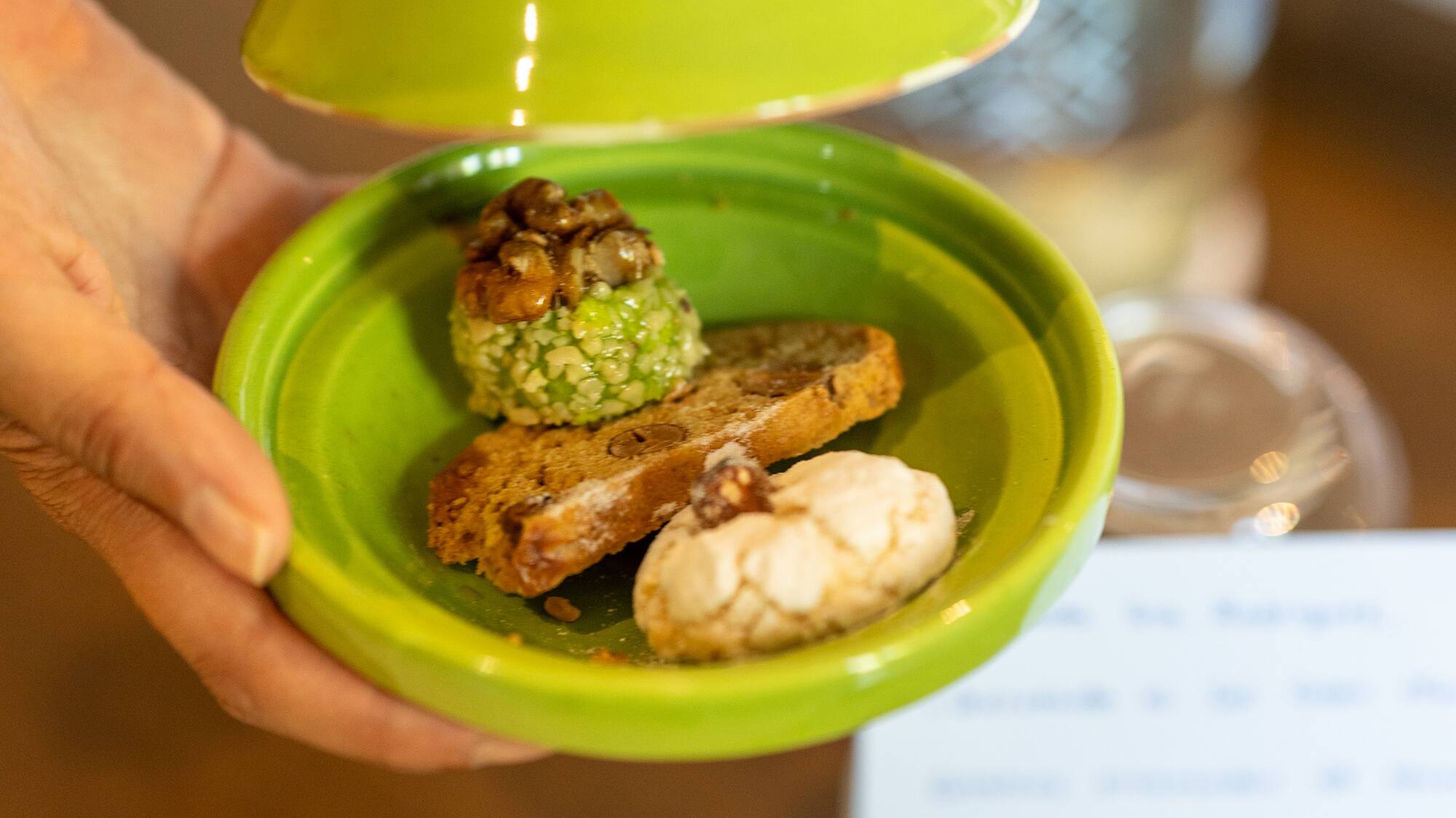 a hand holding a plate of food