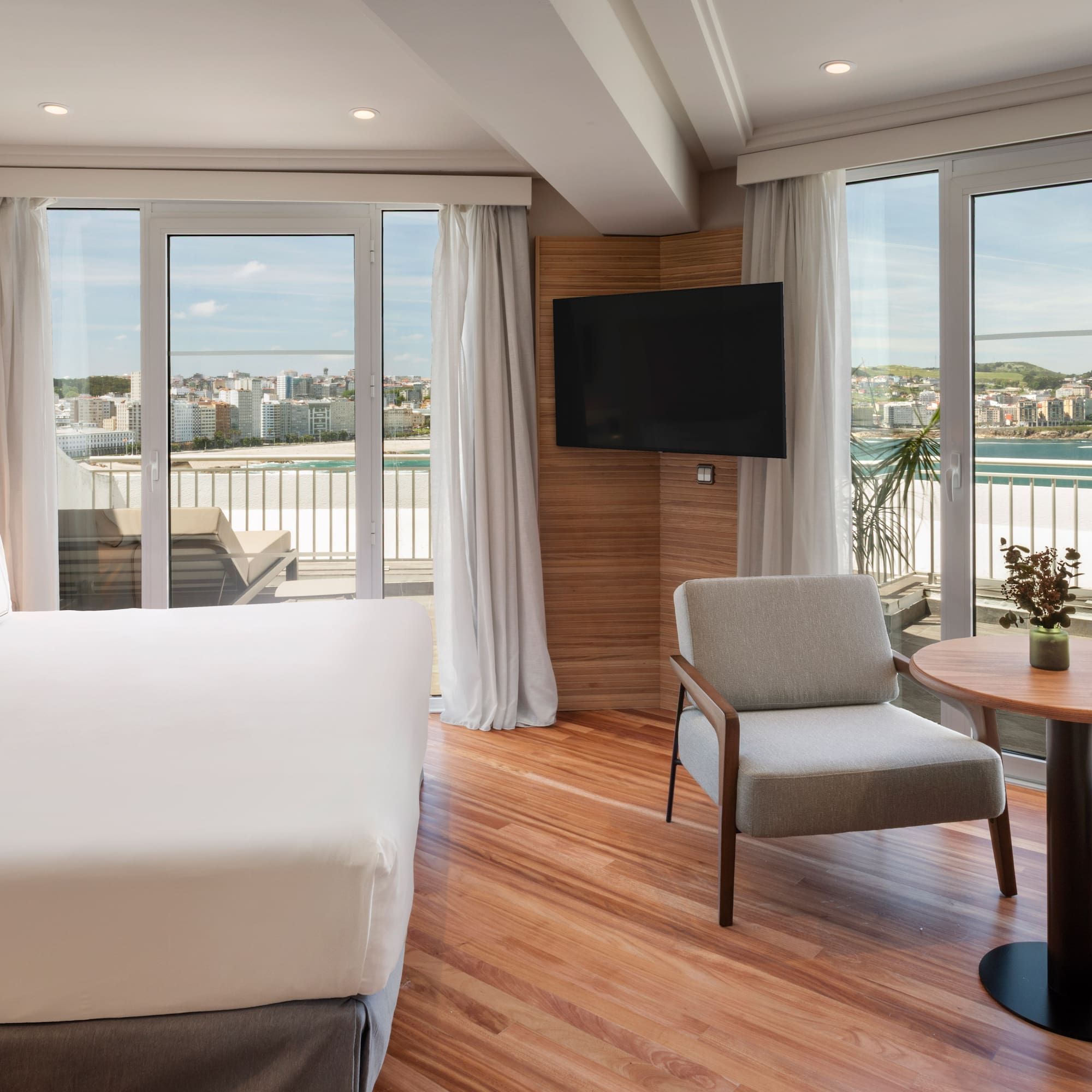 a room with a bed and a chair and a table