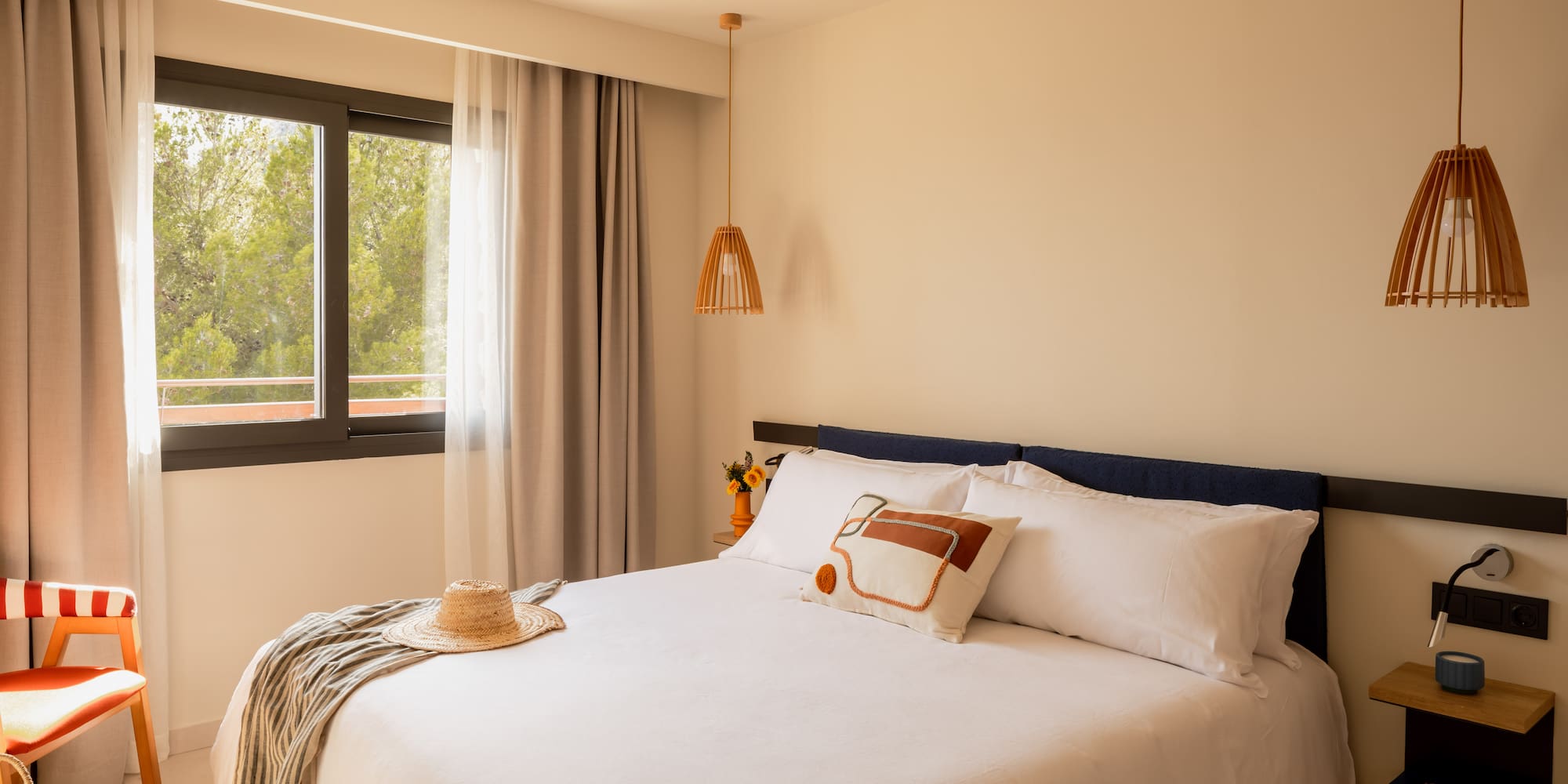 a bed with a hat and a blanket in a room