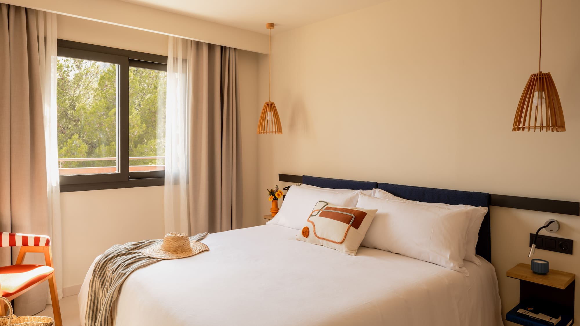 a bed with a hat and a blanket in a room