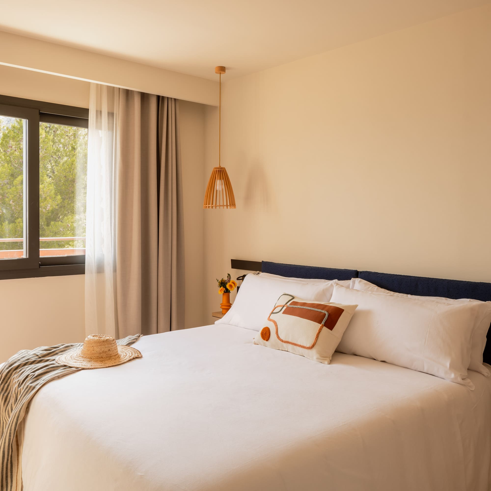 a bed with a hat and a blanket in a room