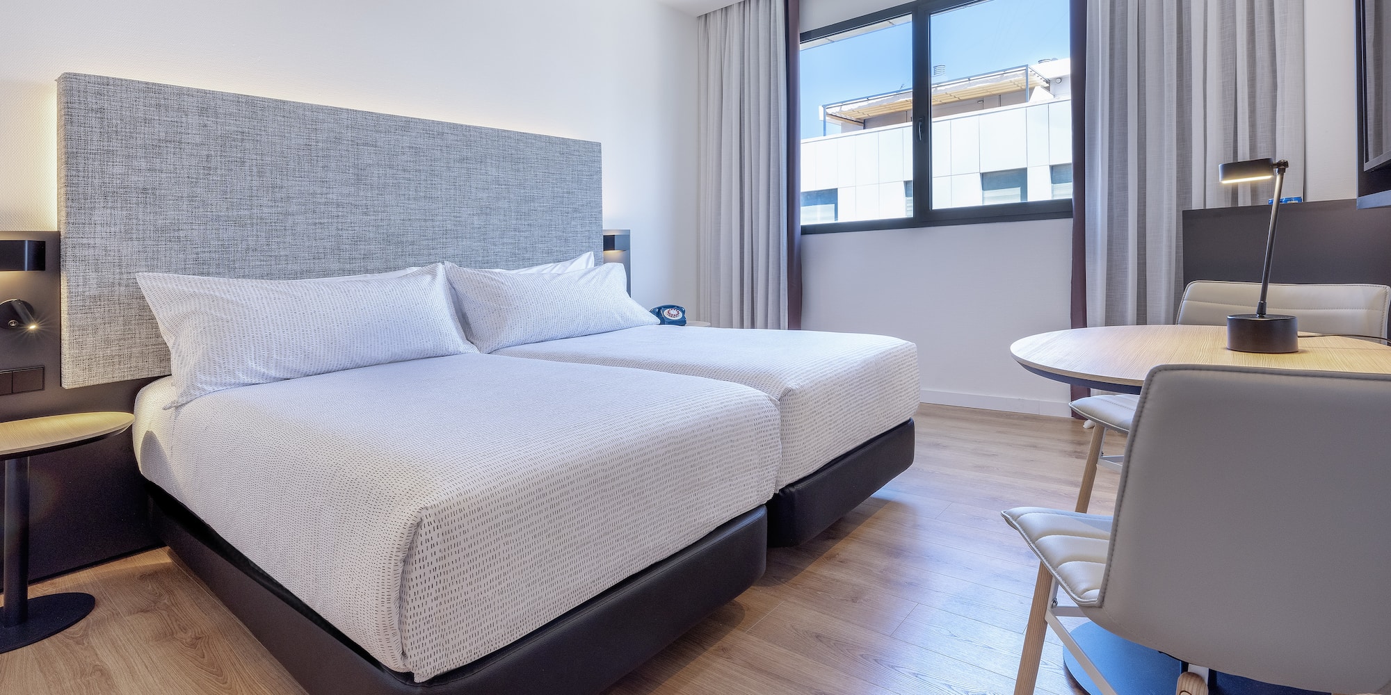 a room with two beds and a table