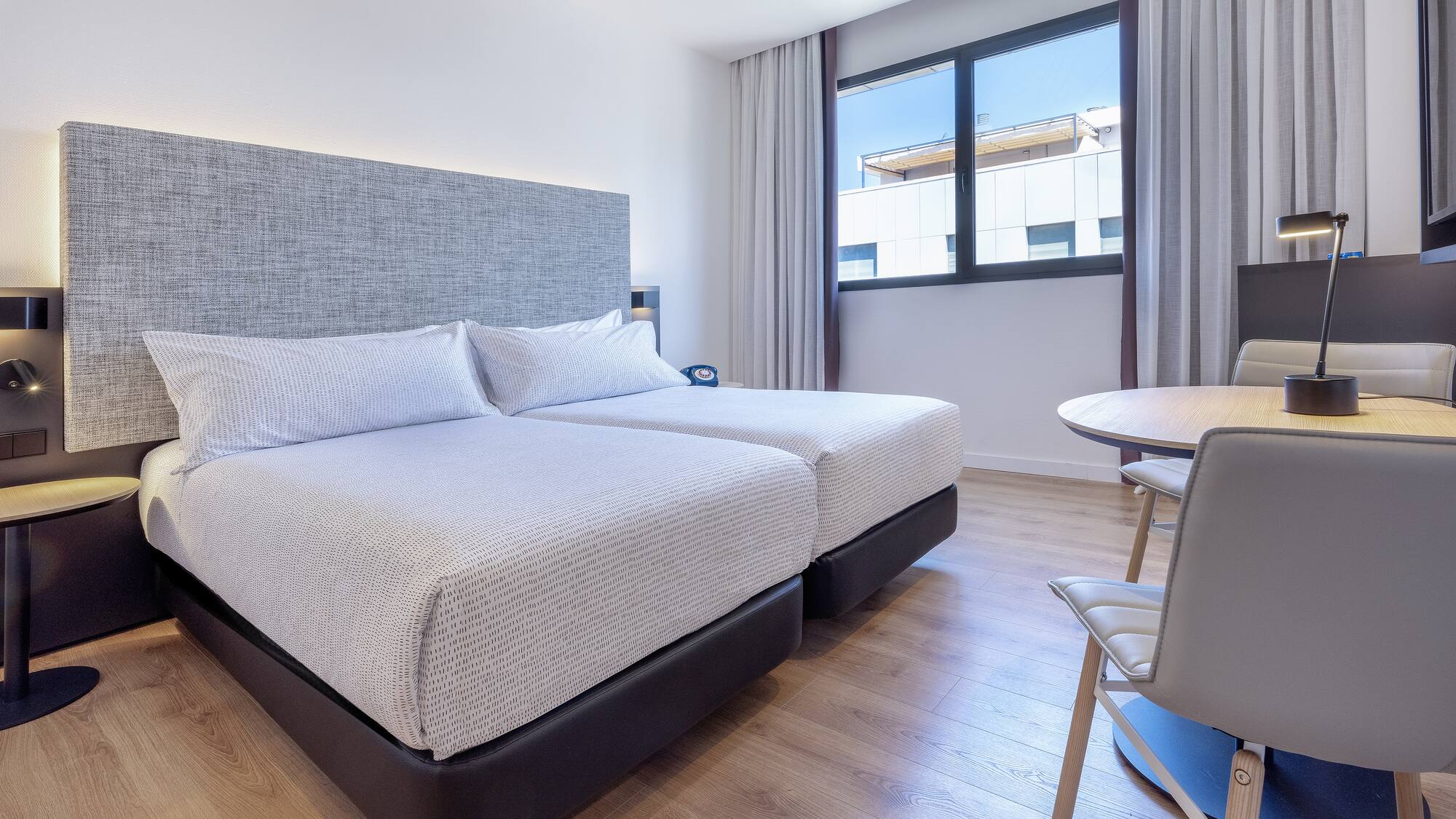 a room with two beds and a table