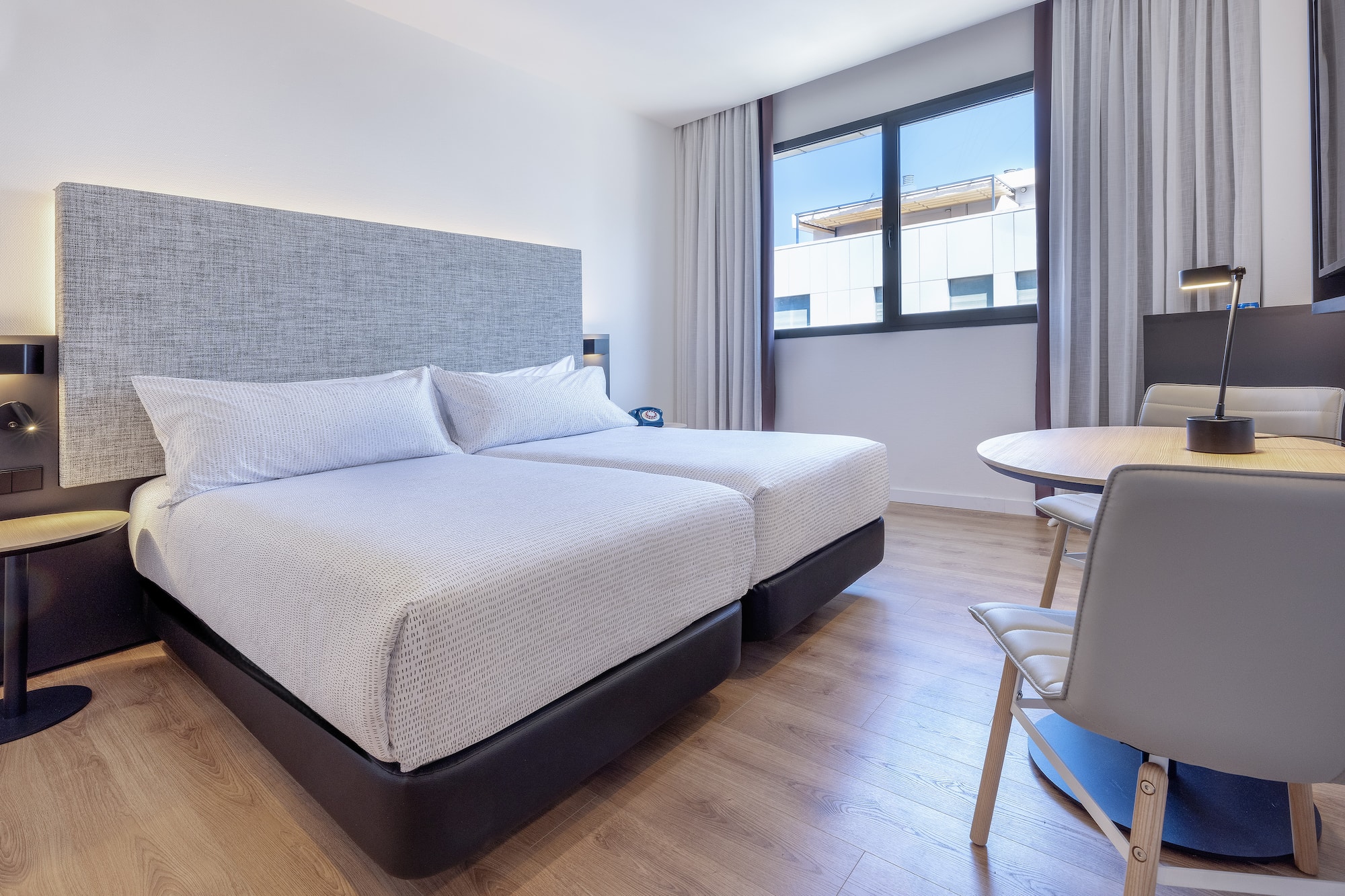 a room with two beds and a table