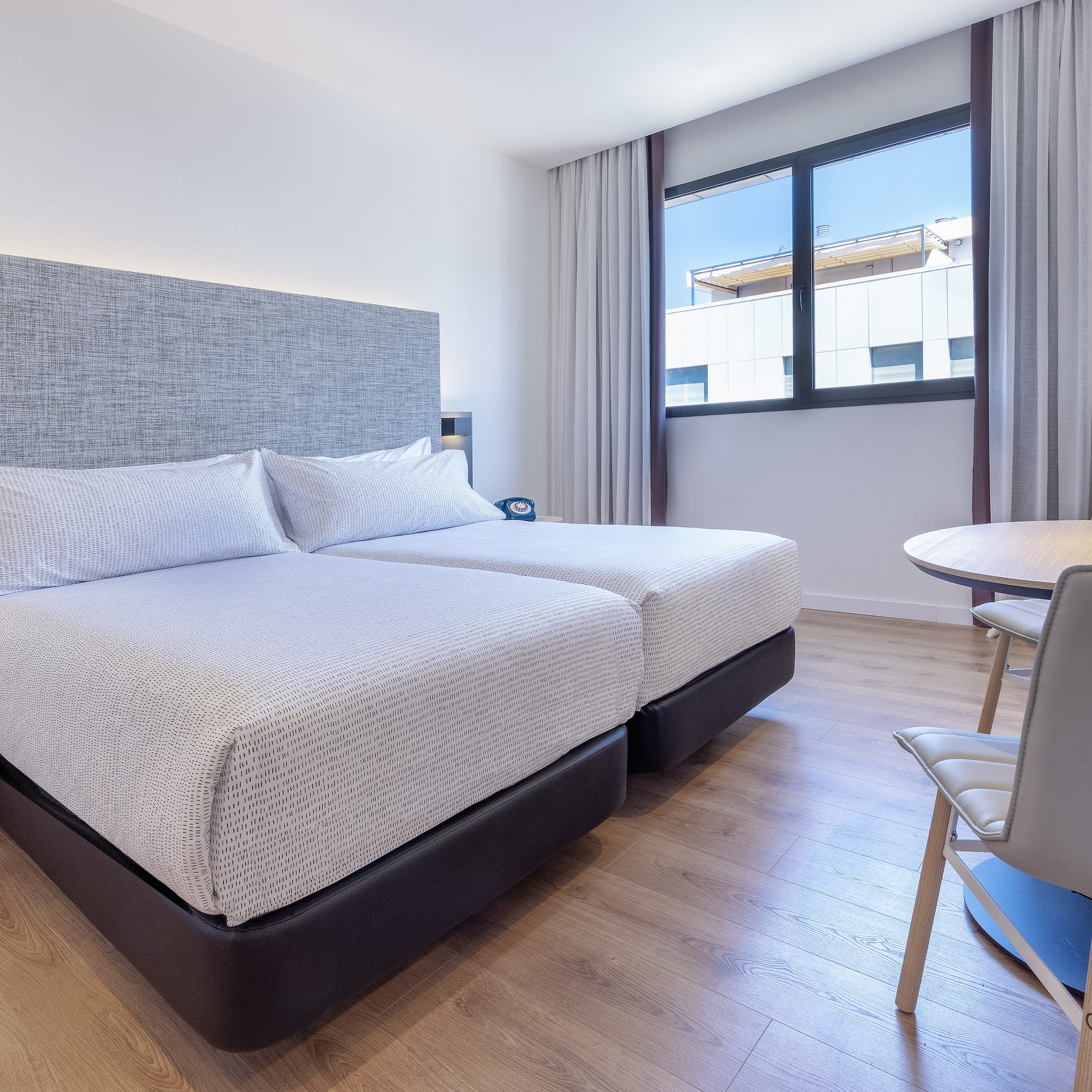 a room with two beds and a table