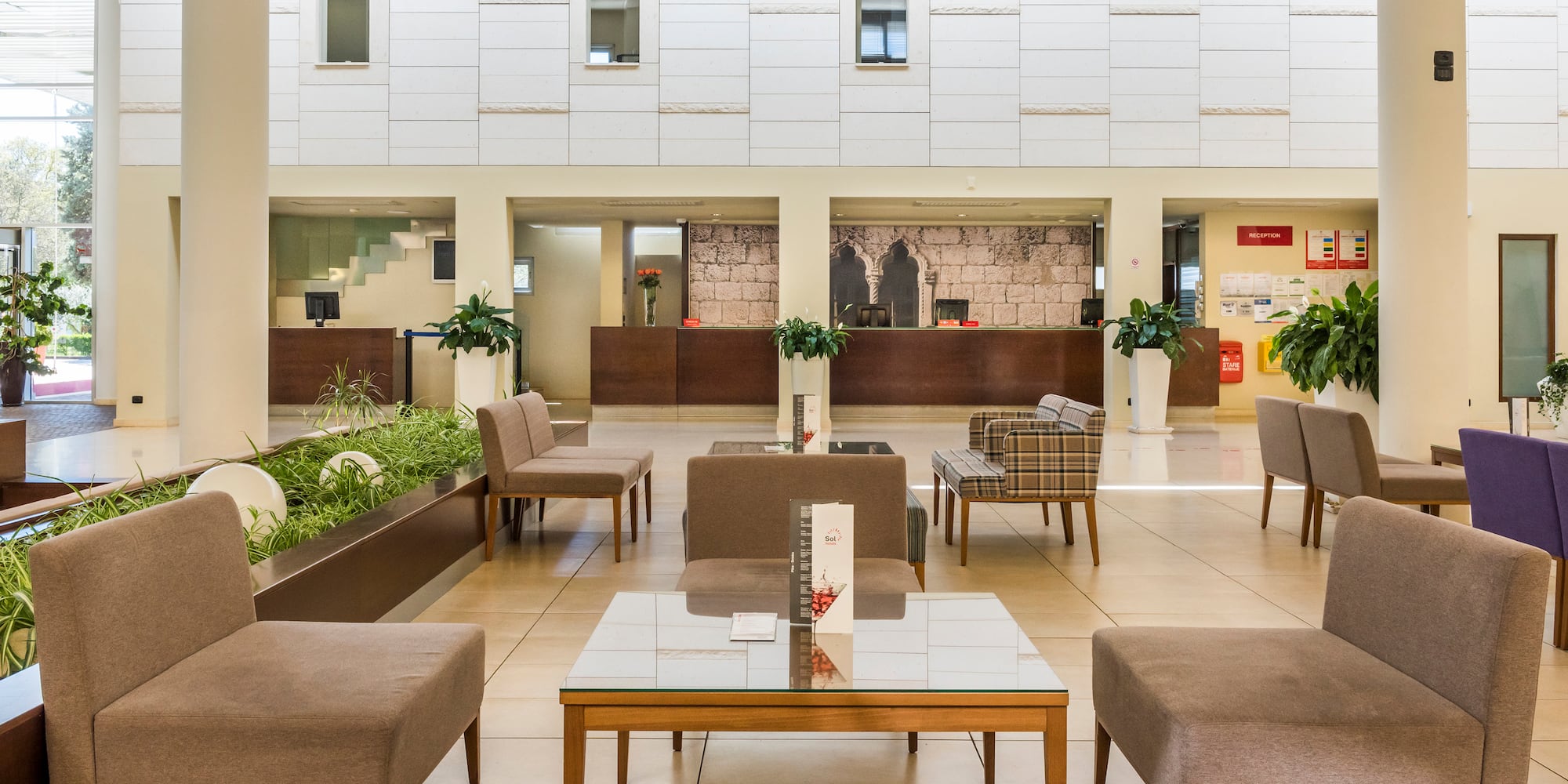 a room with a large white wall and a large window