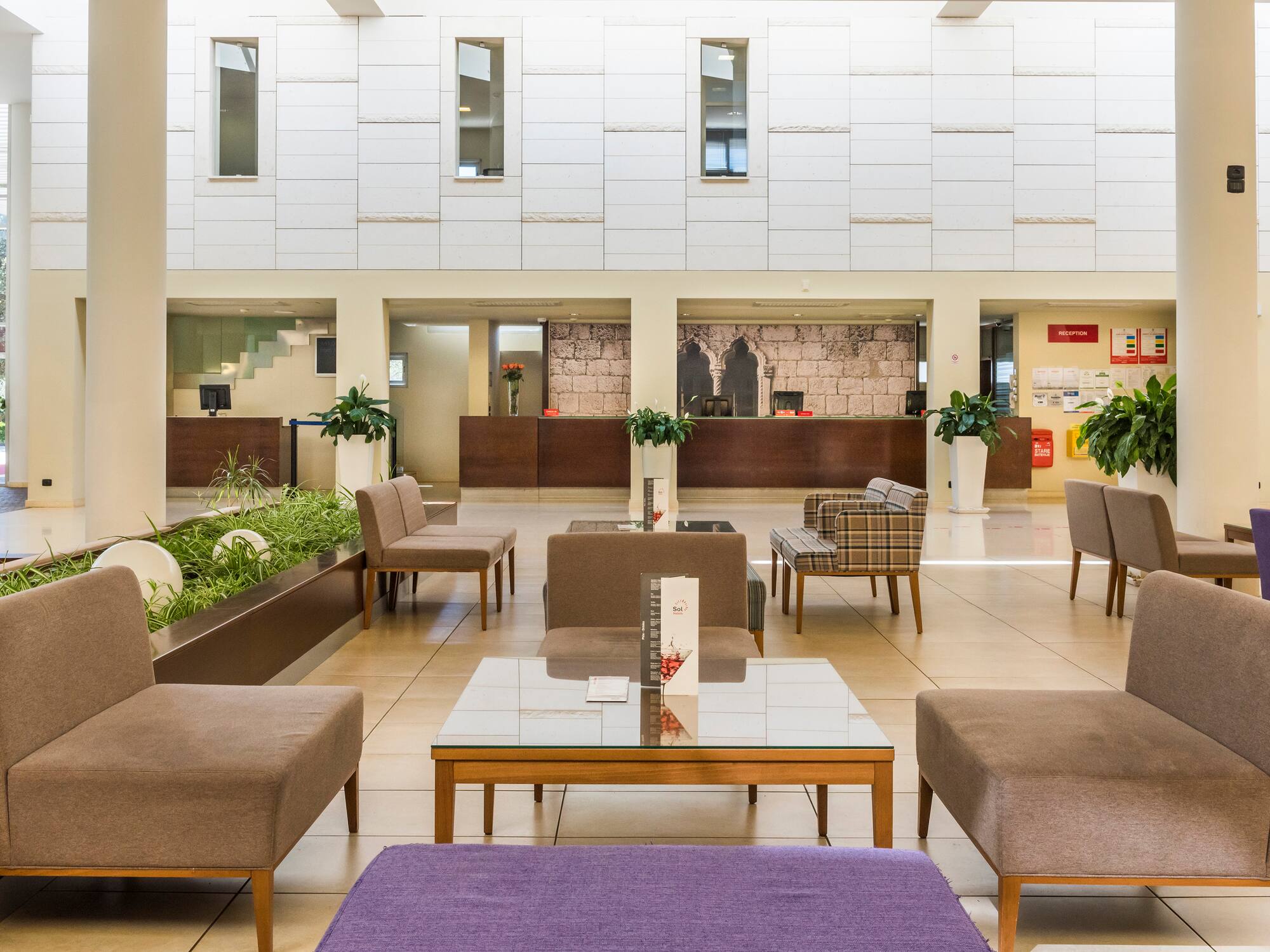 a room with a large white wall and a large window