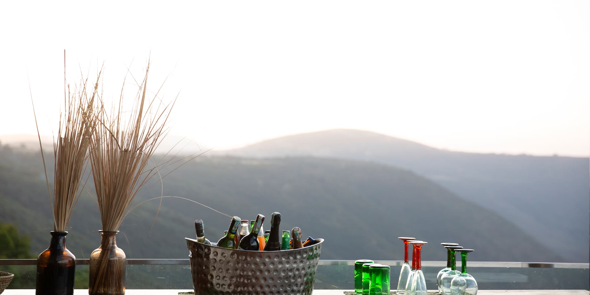 a glass bottles in a basket on a table