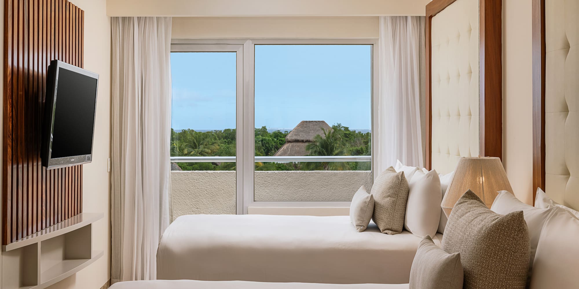 a room with two beds and a window