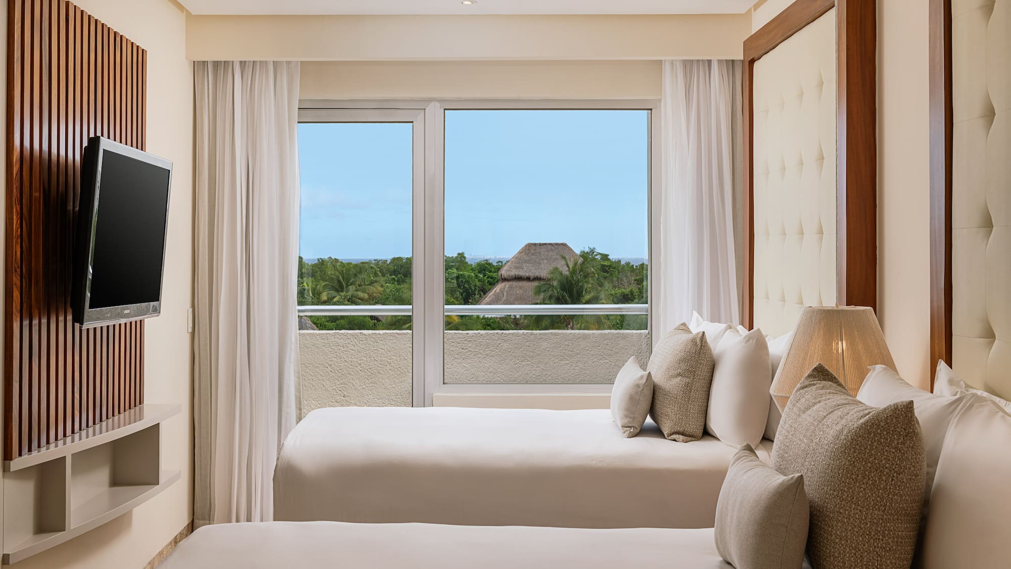 a room with two beds and a window