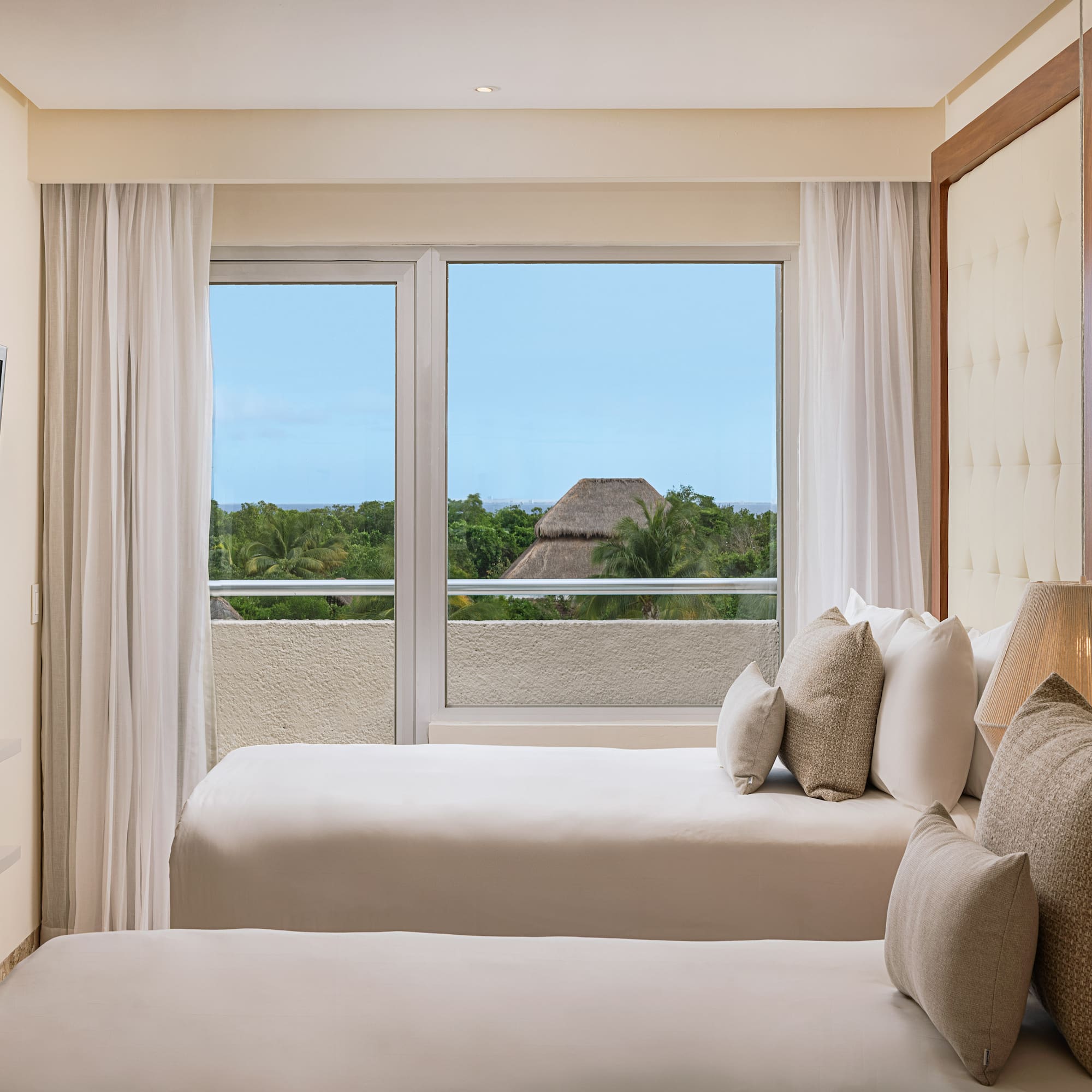 a room with two beds and a window