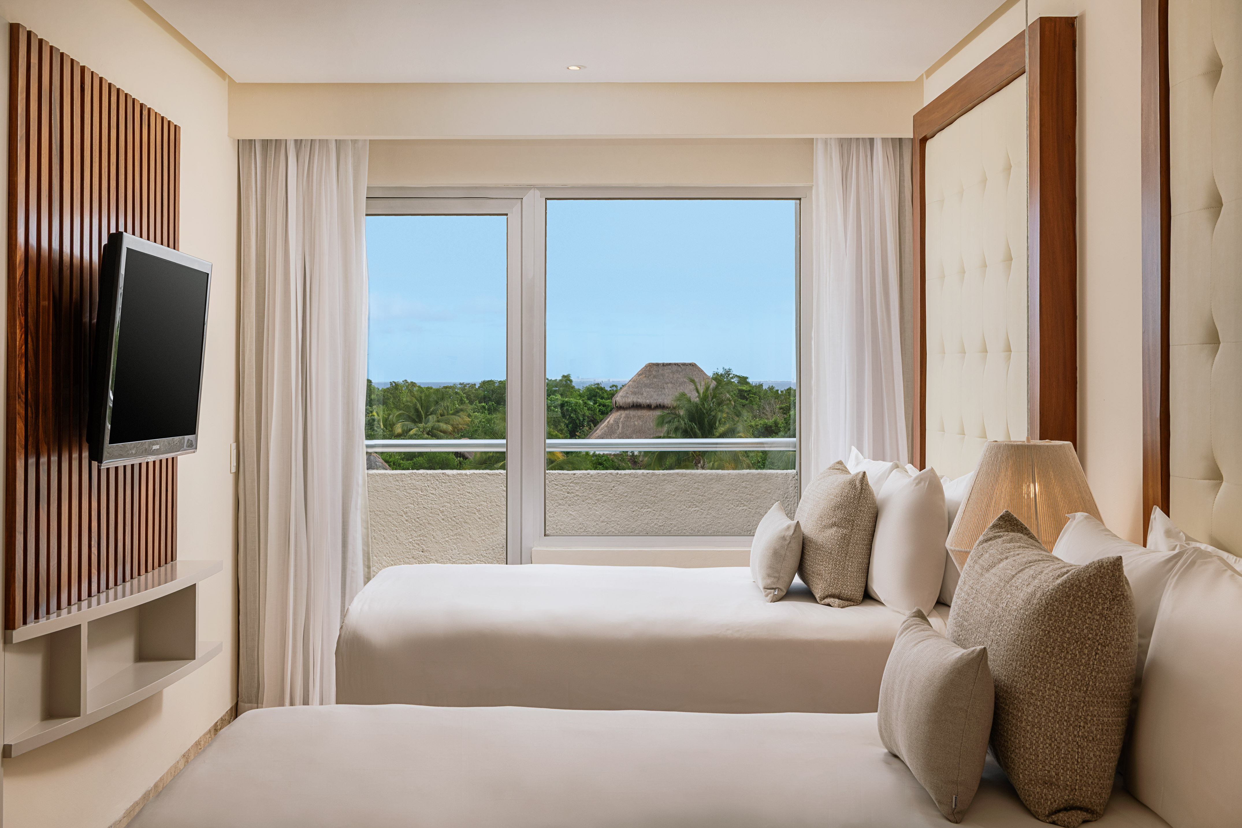 a room with two beds and a window