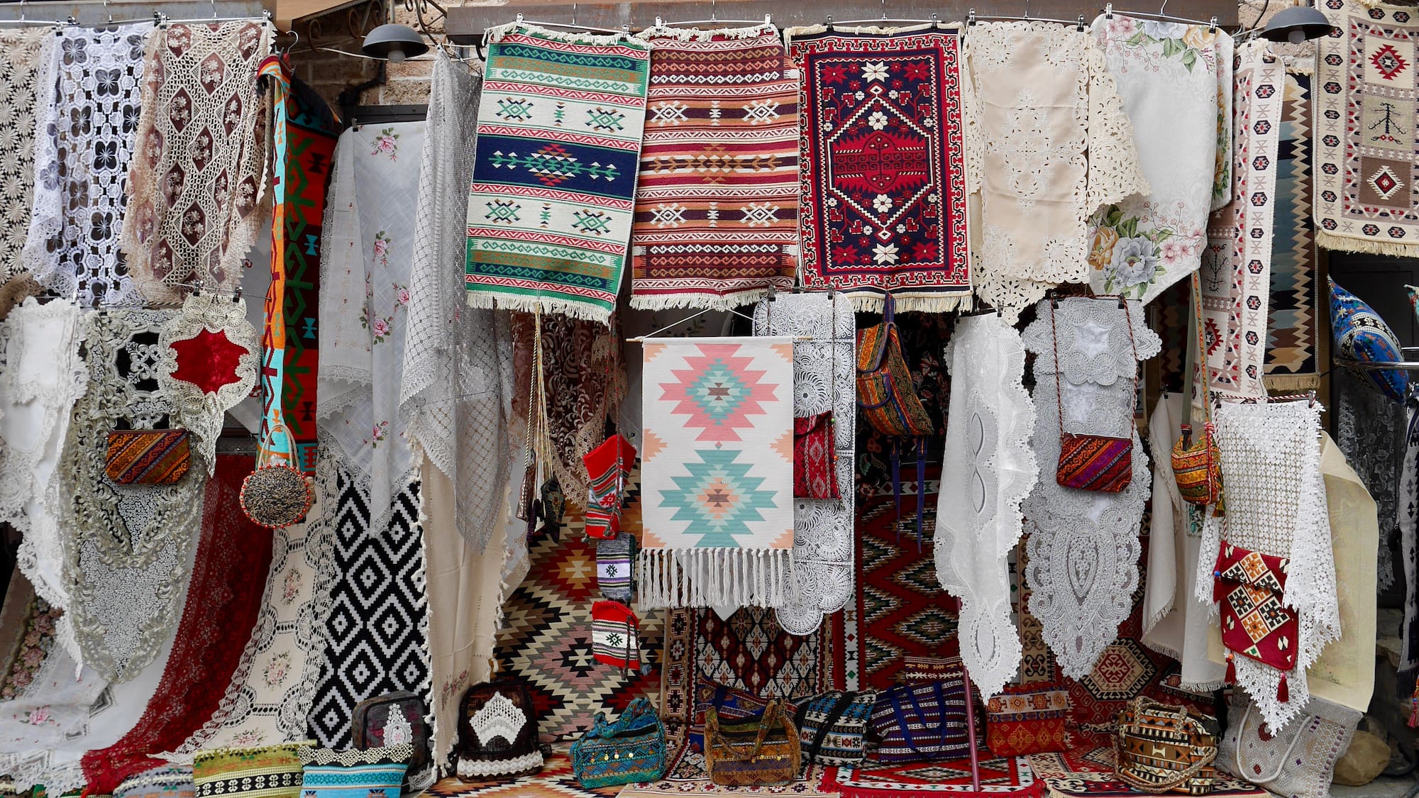 a store with colorful rugs and blankets