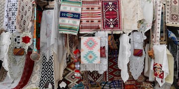 a store with colorful rugs and blankets