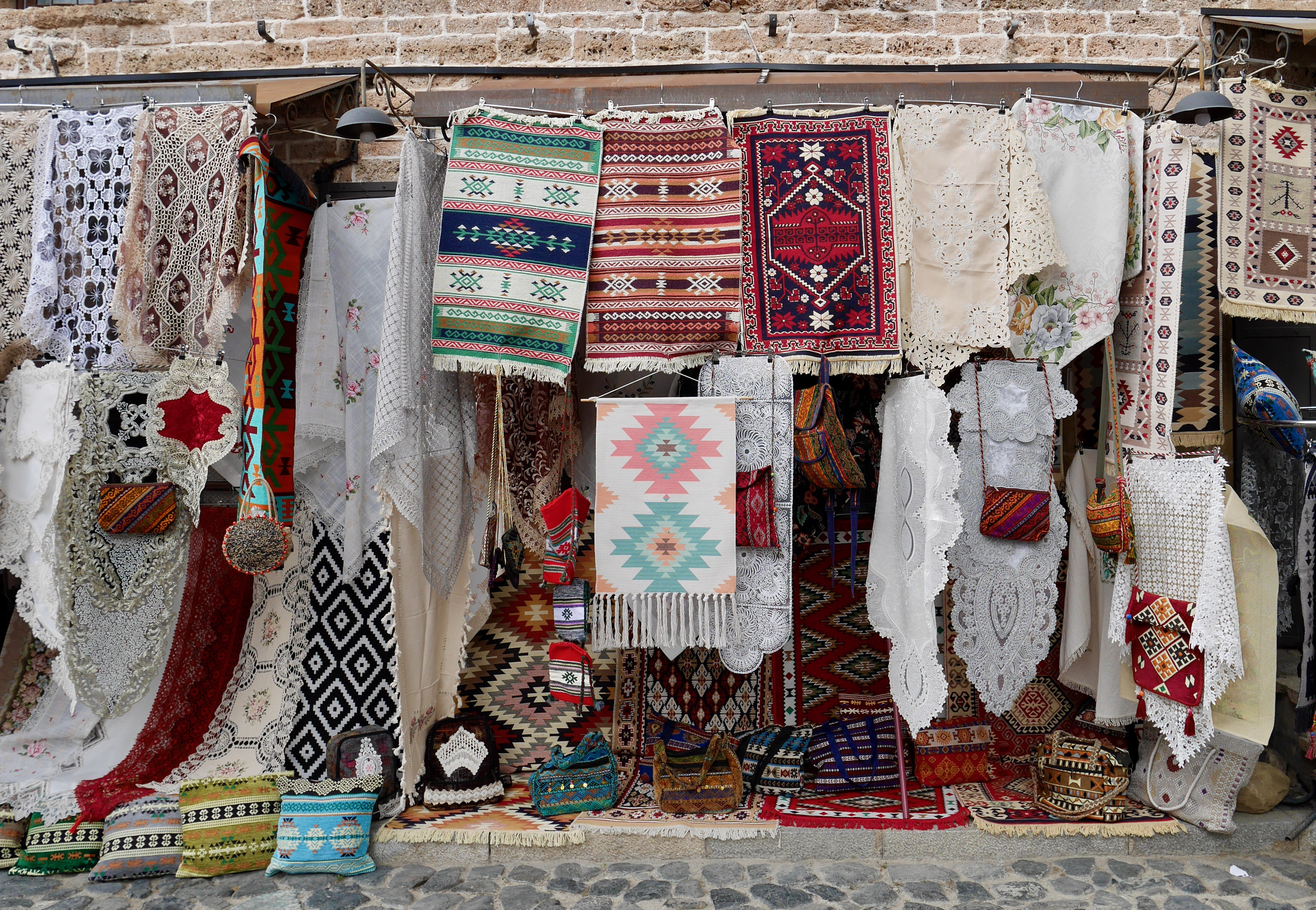 a store with colorful rugs and blankets