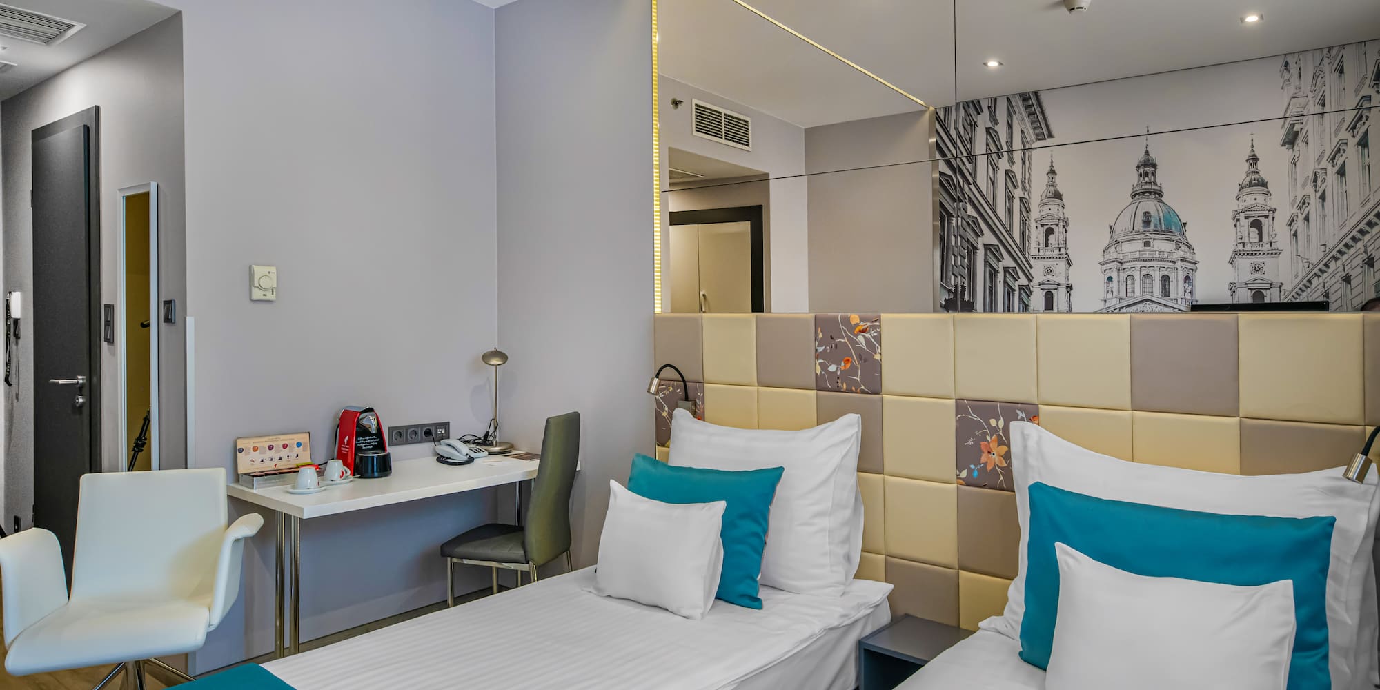 a room with two beds and a mirror