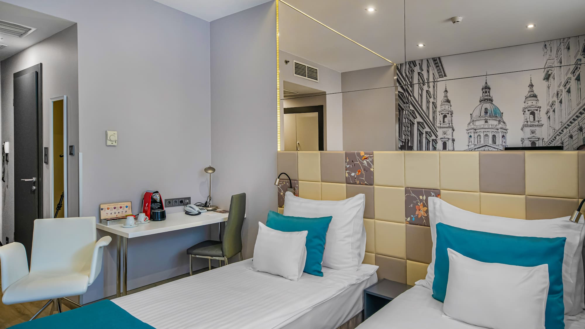 a room with two beds and a mirror