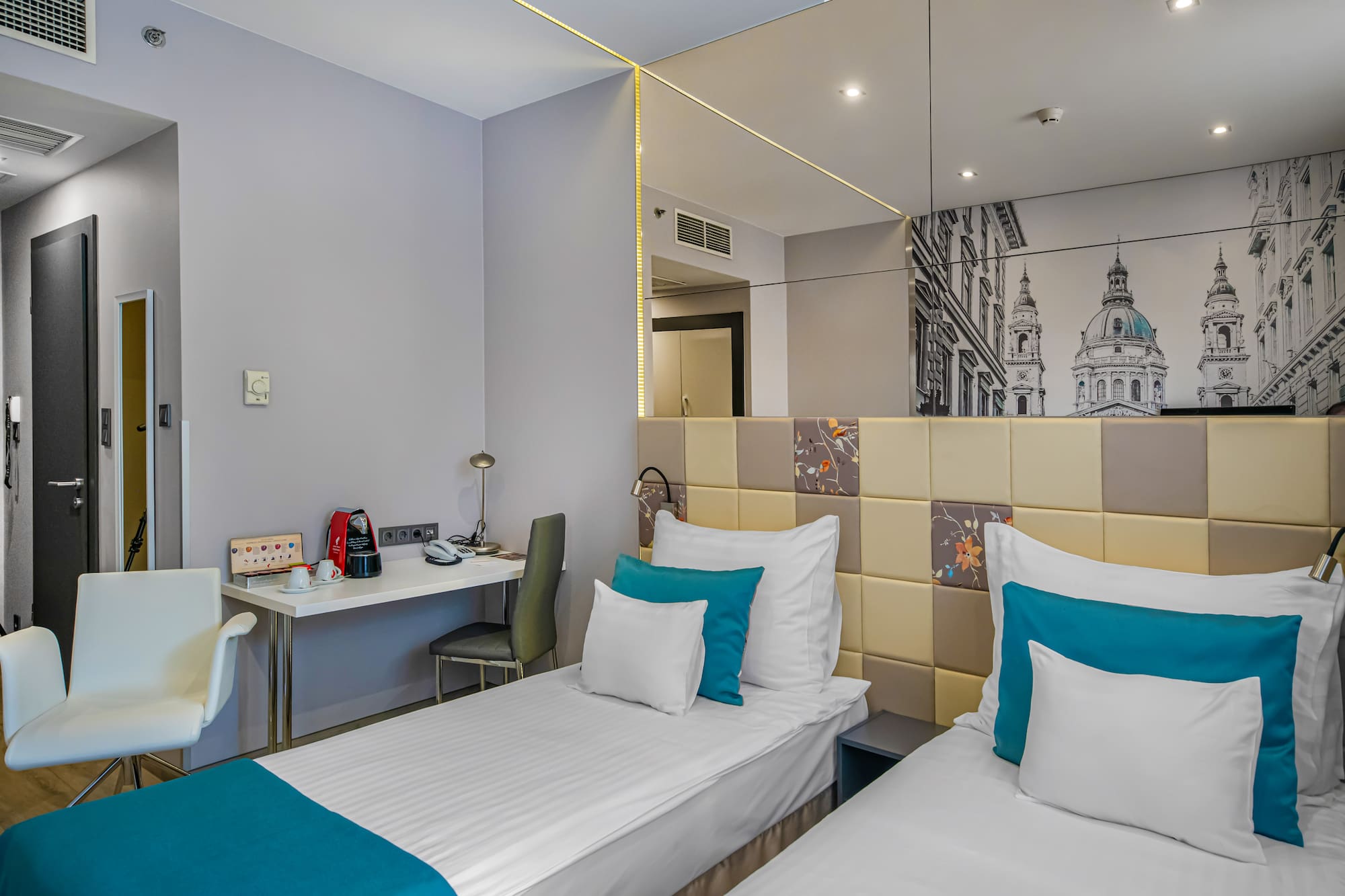 a room with two beds and a mirror