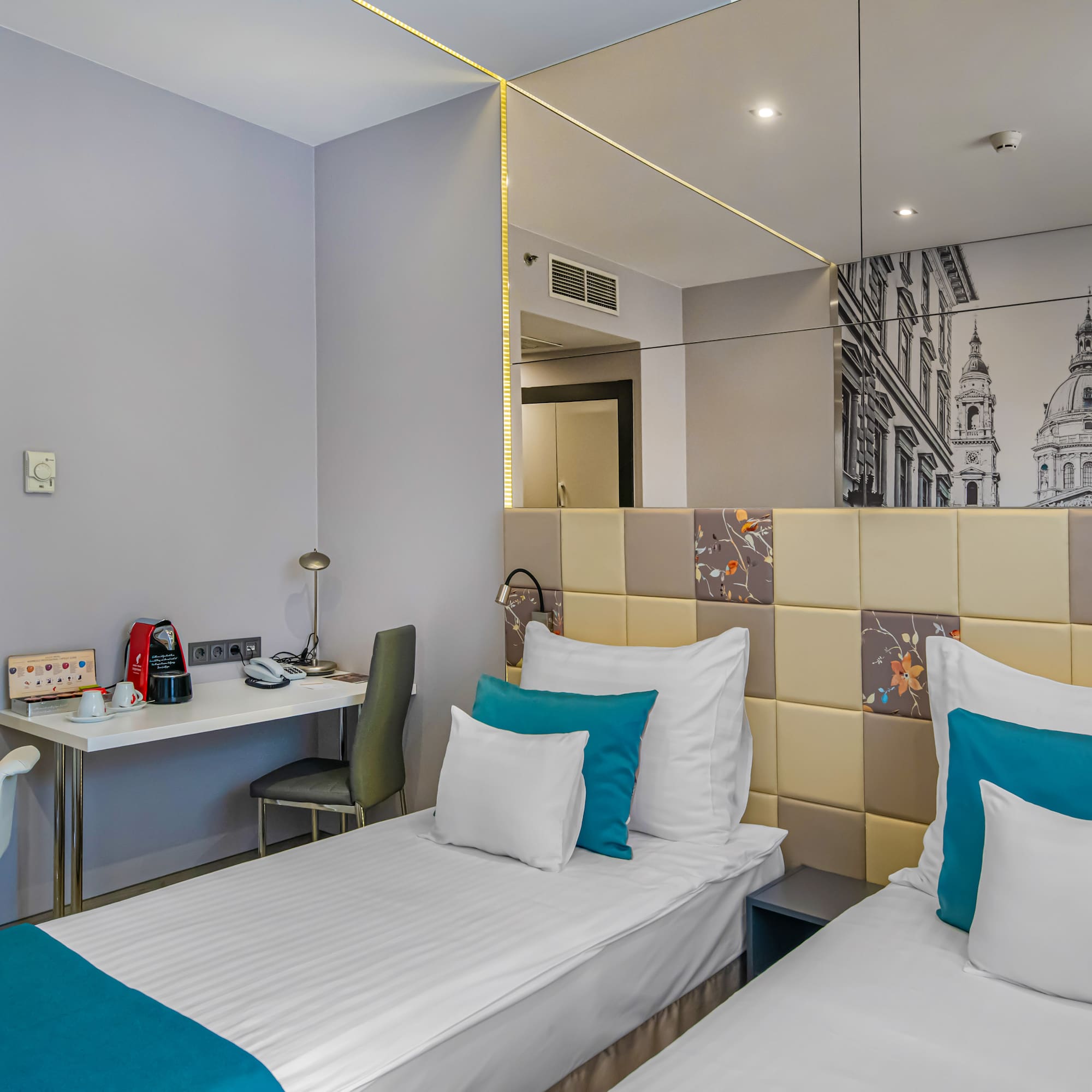 a room with two beds and a mirror