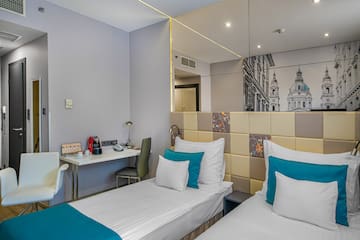 a room with two beds and a mirror