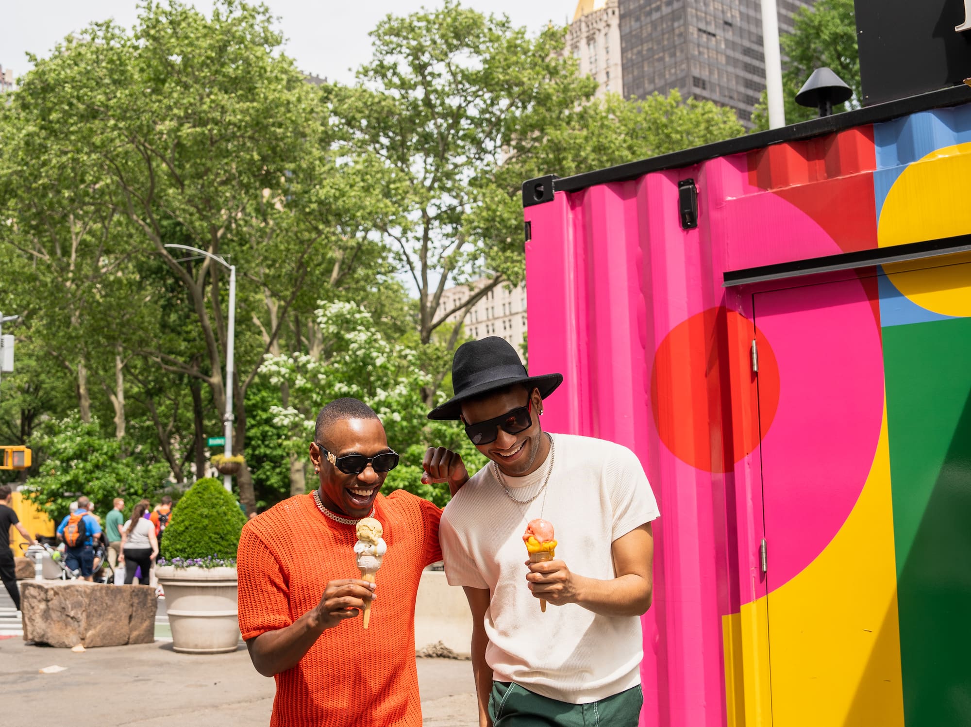 two men walking down a street with ice cream