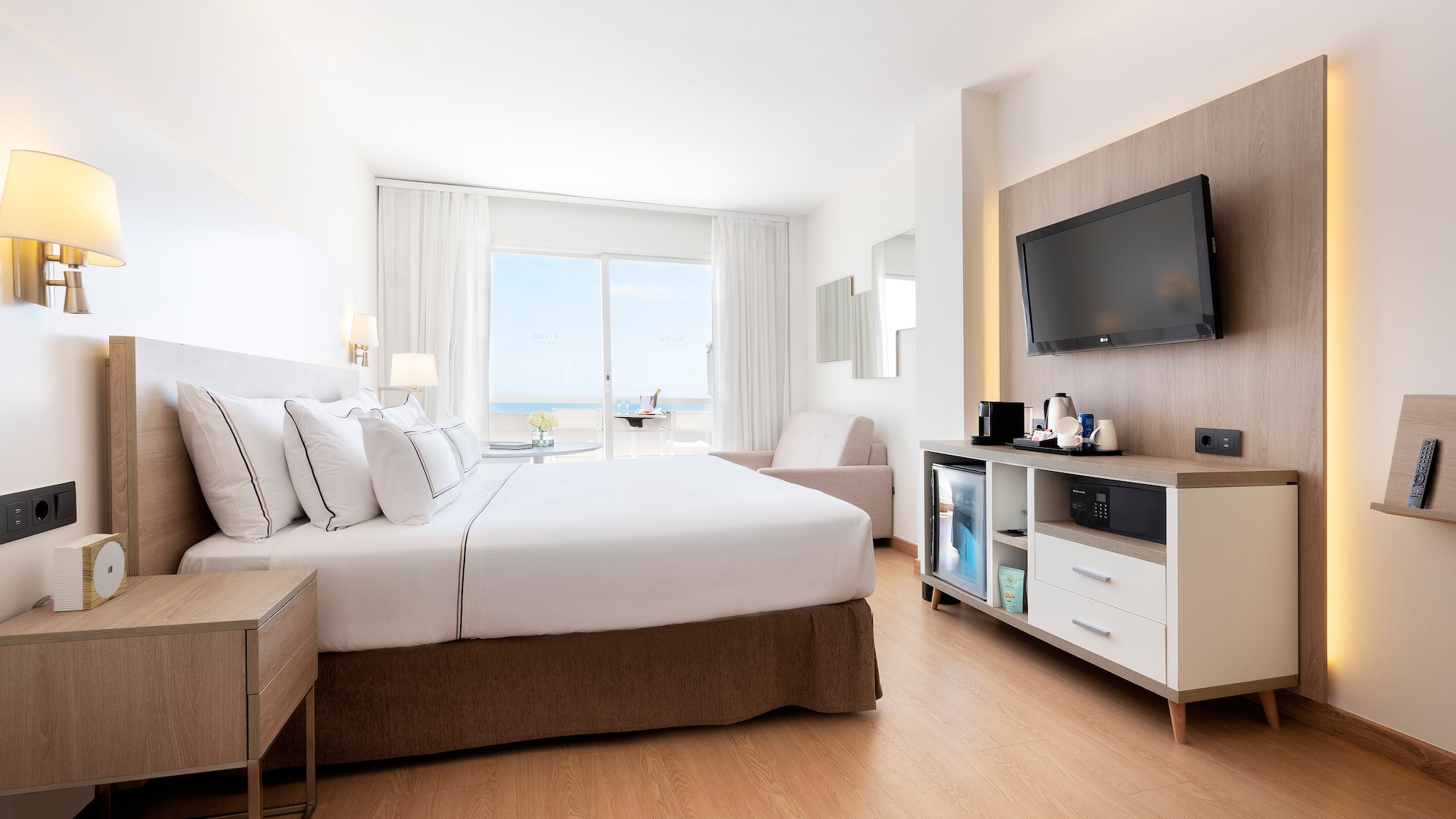 a room with a bed and a television