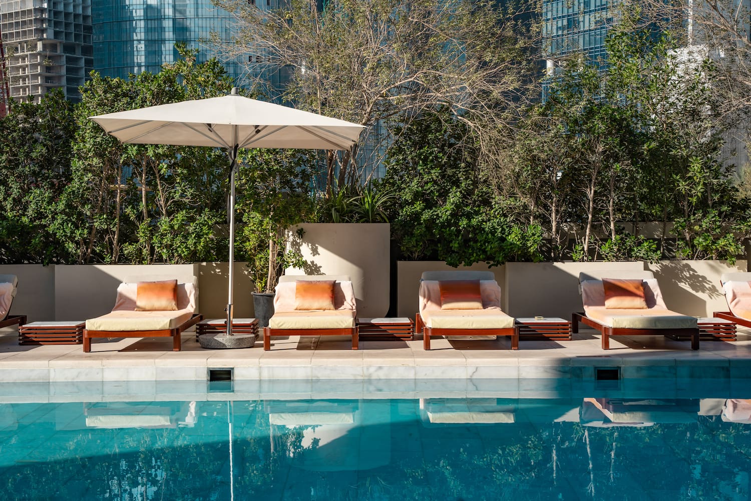 a pool with chairs and umbrella