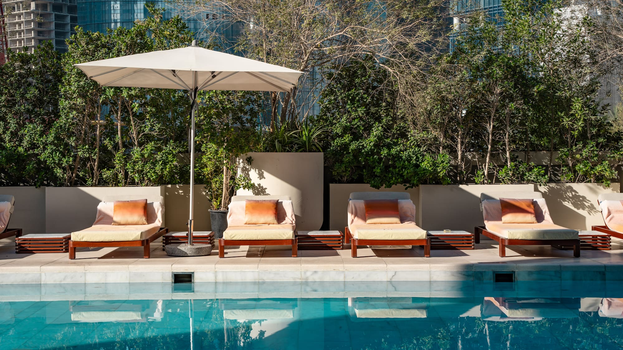 a pool with chairs and umbrella