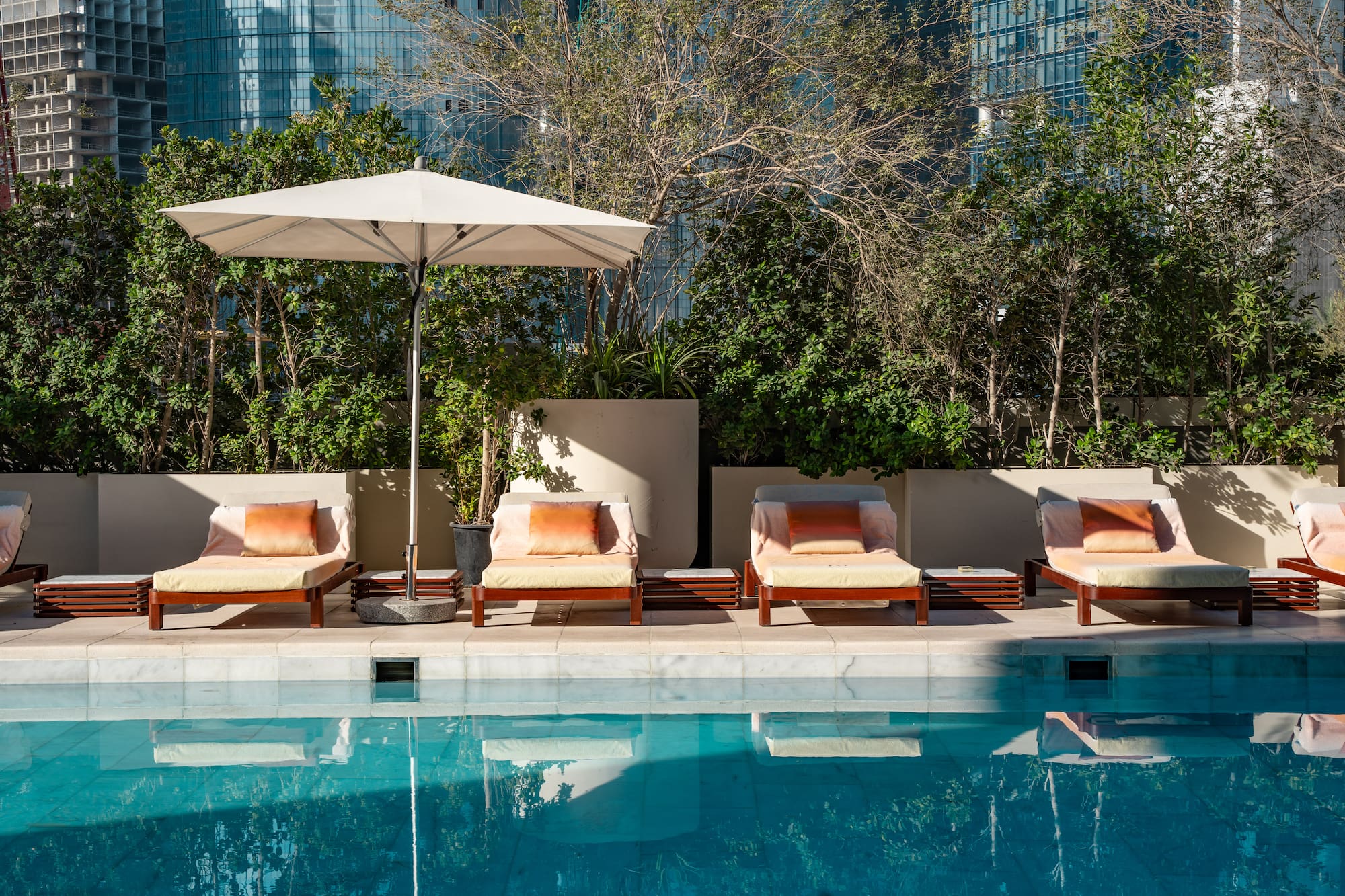 a pool with chairs and umbrella