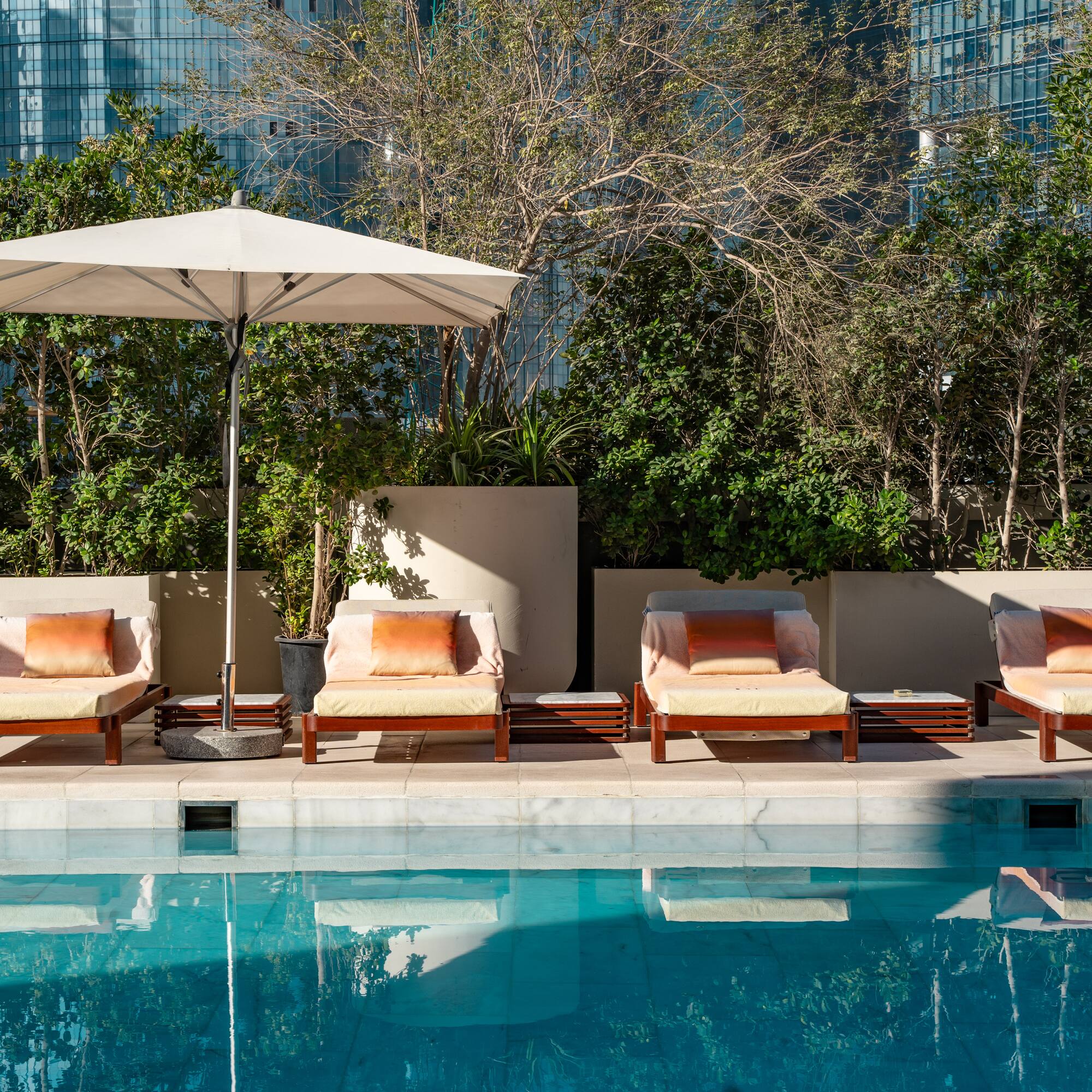 a pool with chairs and umbrella